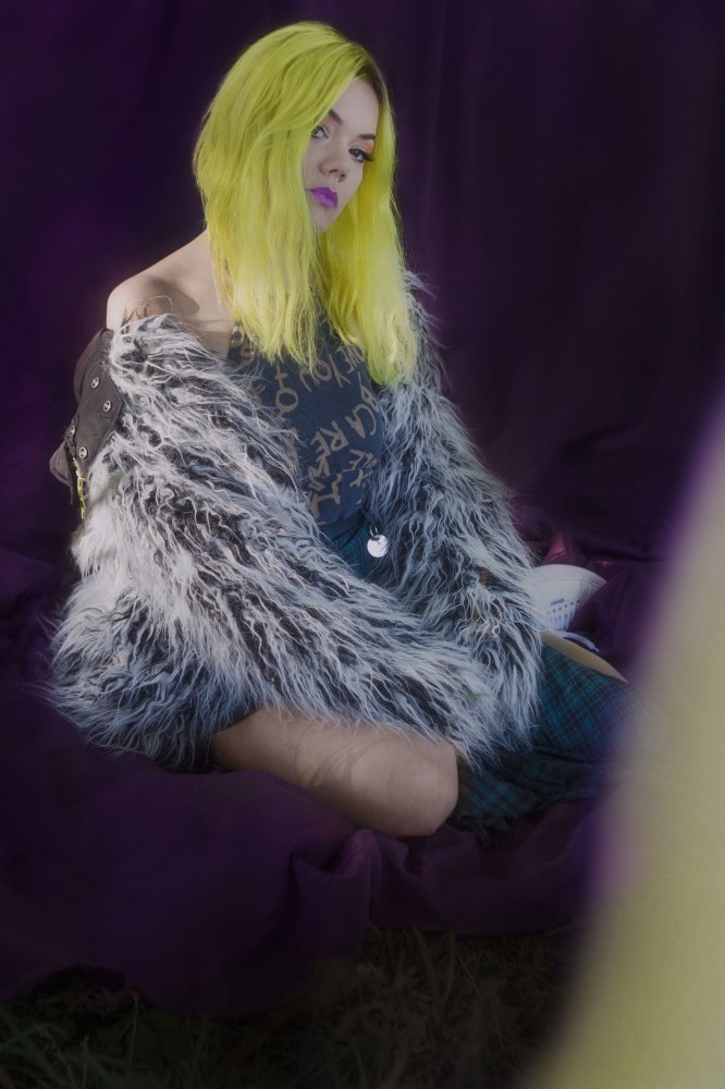 a woman with yellow hair and a fur coat