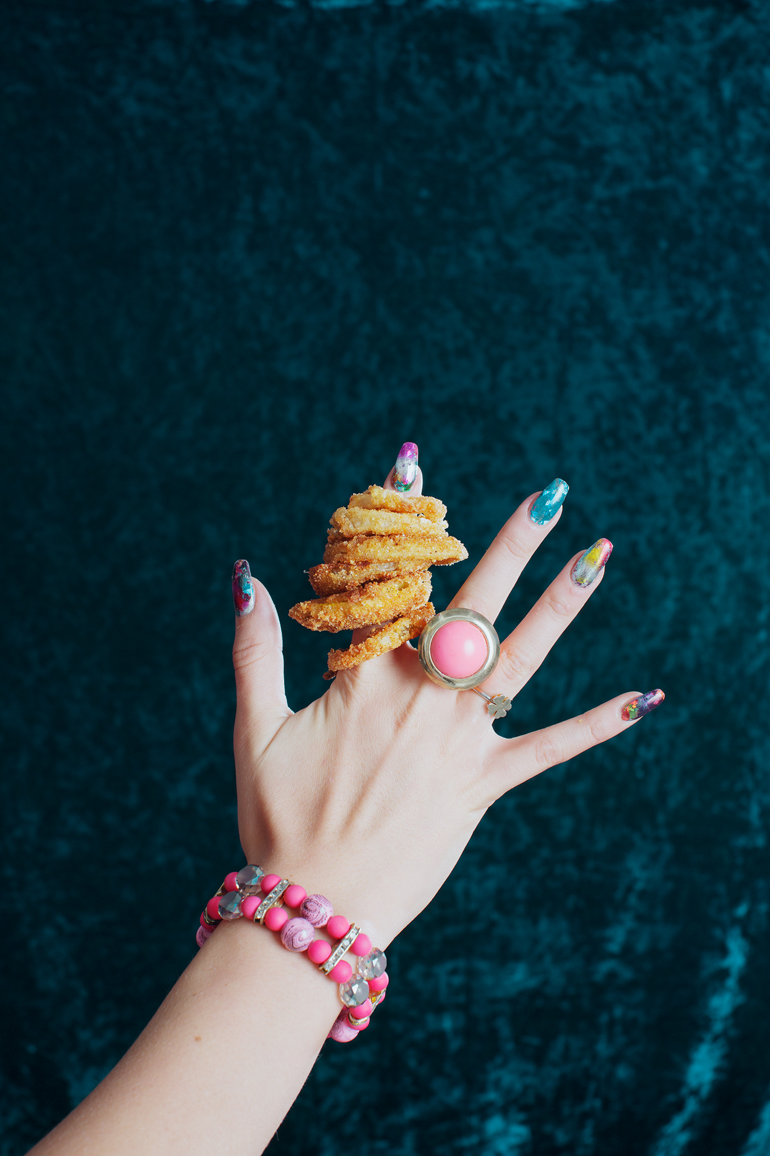 a hand holding food on a blue background