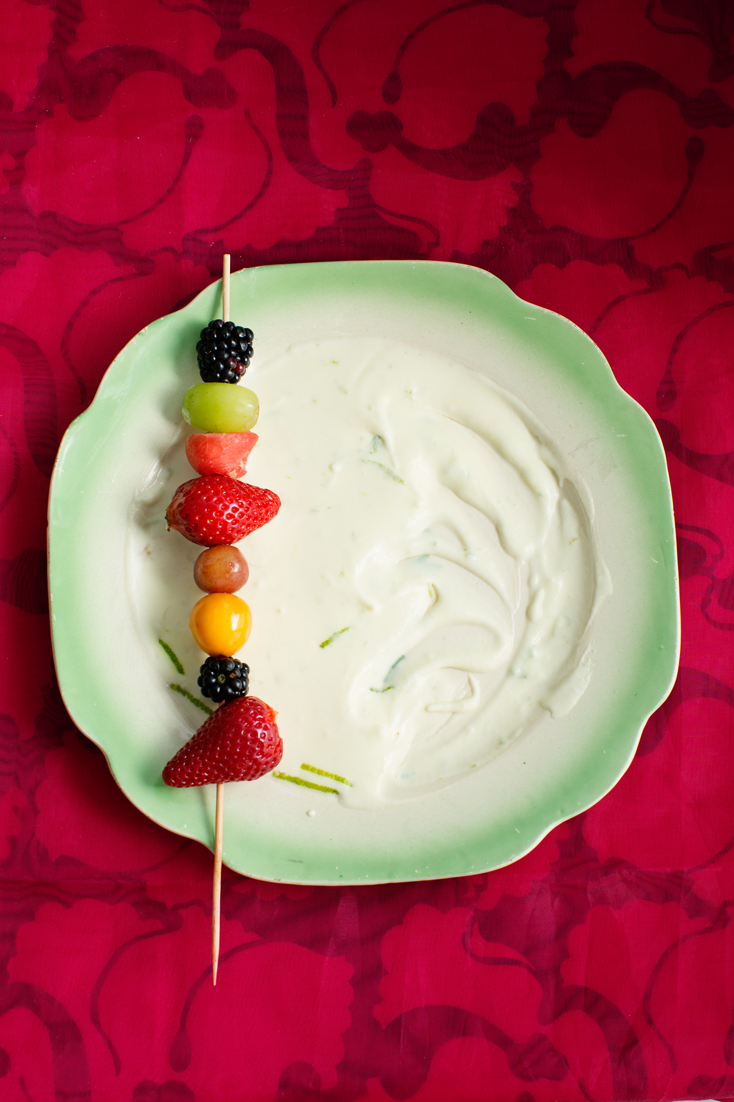 a plate of fruit on a stick