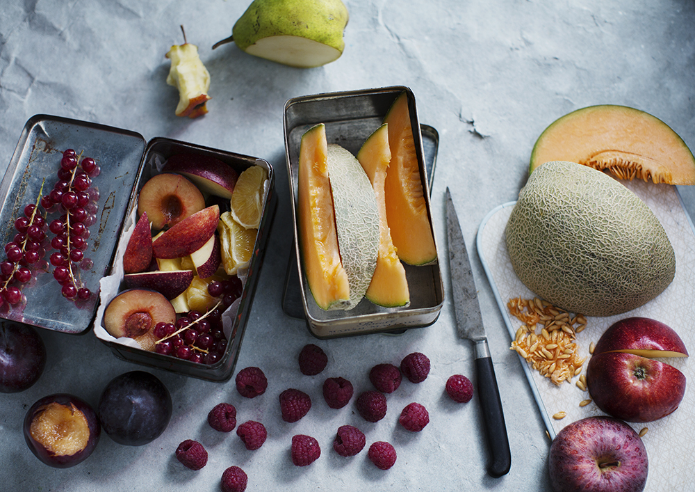 a group of containers with fruit