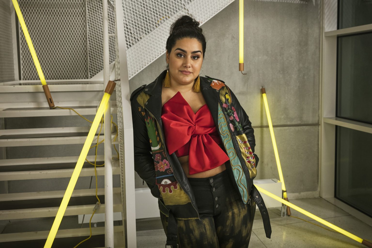 a woman standing in front of stairs