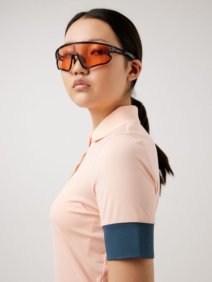 a woman wearing orange safety glasses