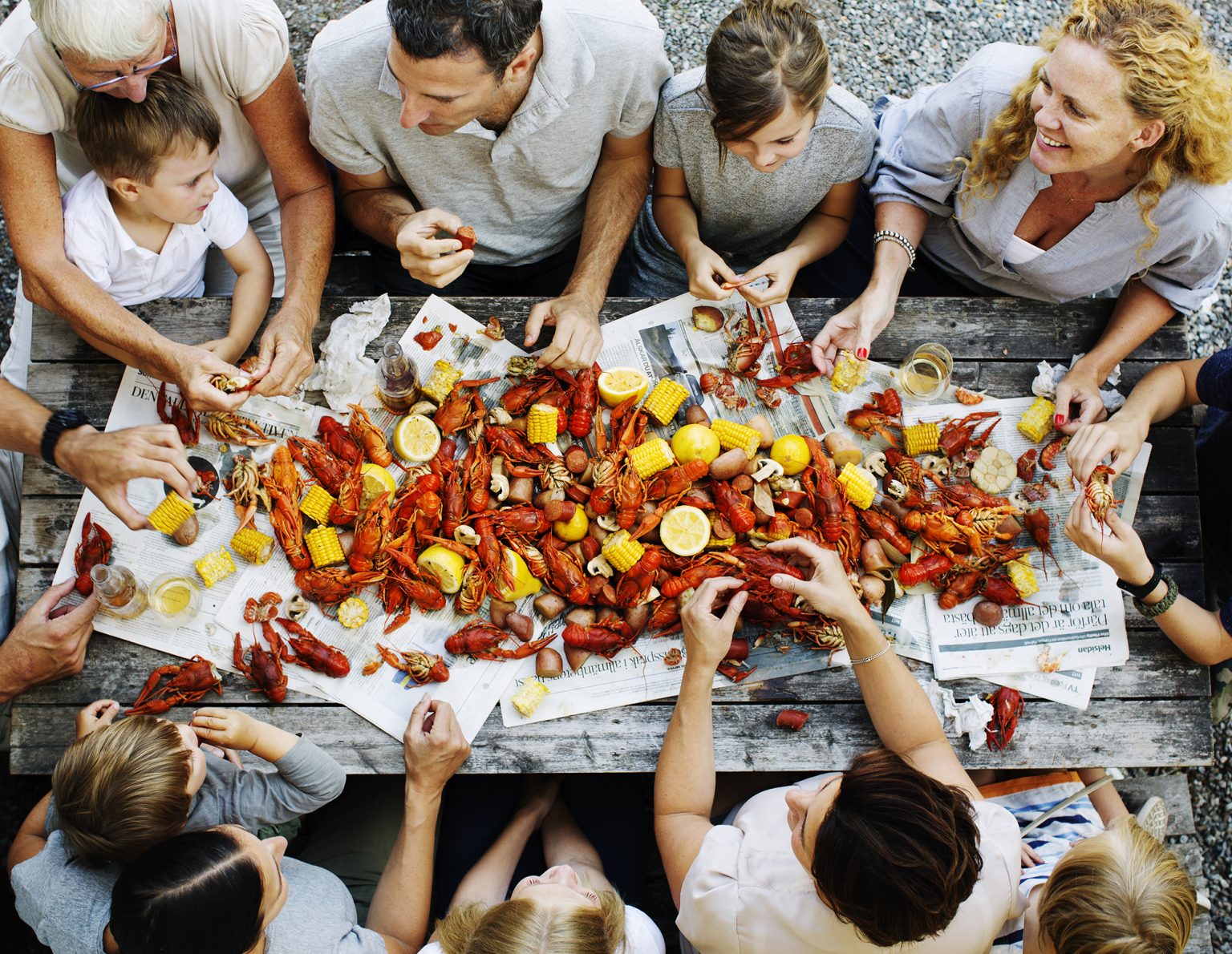 a group of people around a table with crawfish