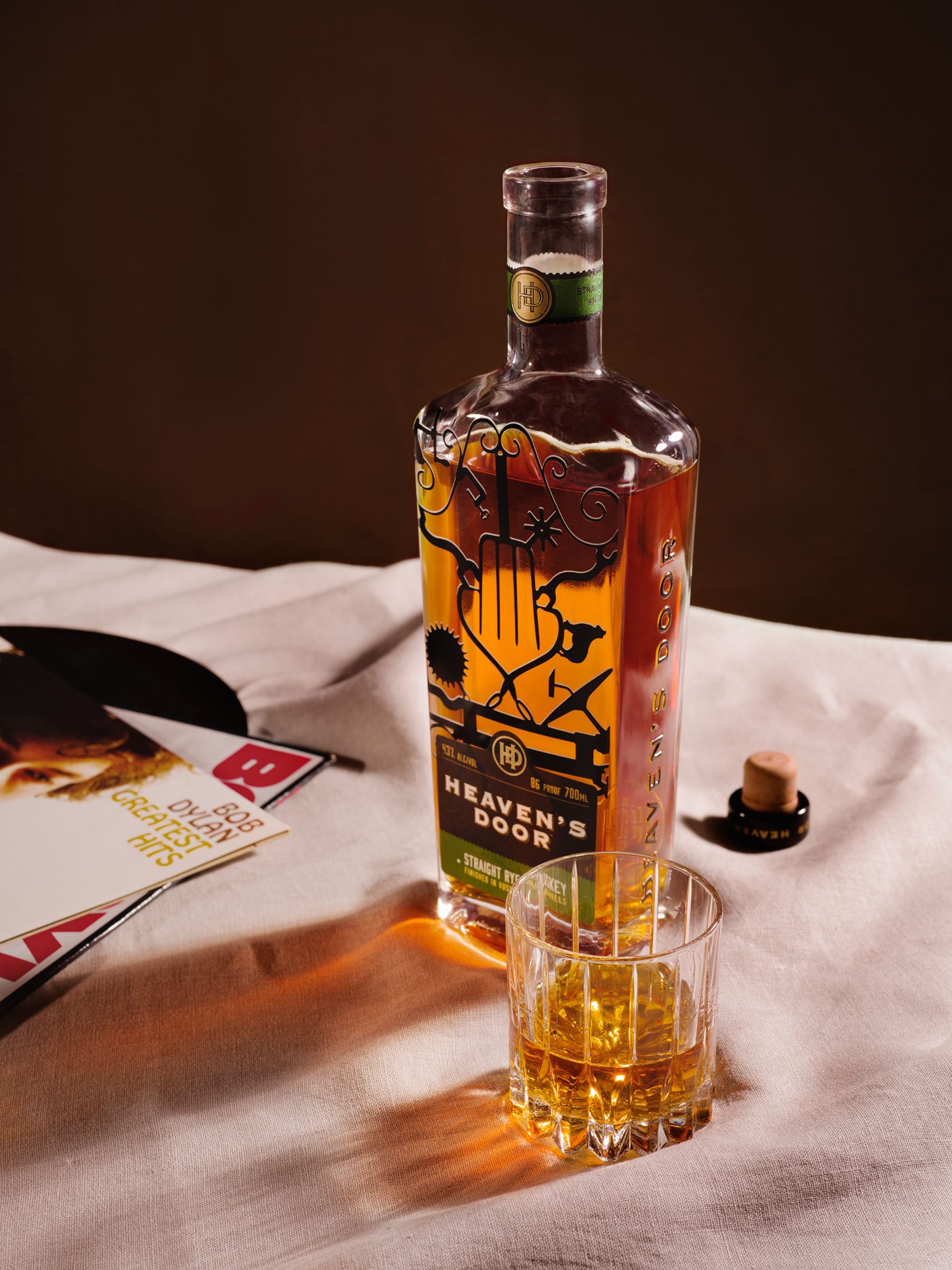 a bottle of alcohol next to a glass of liquid