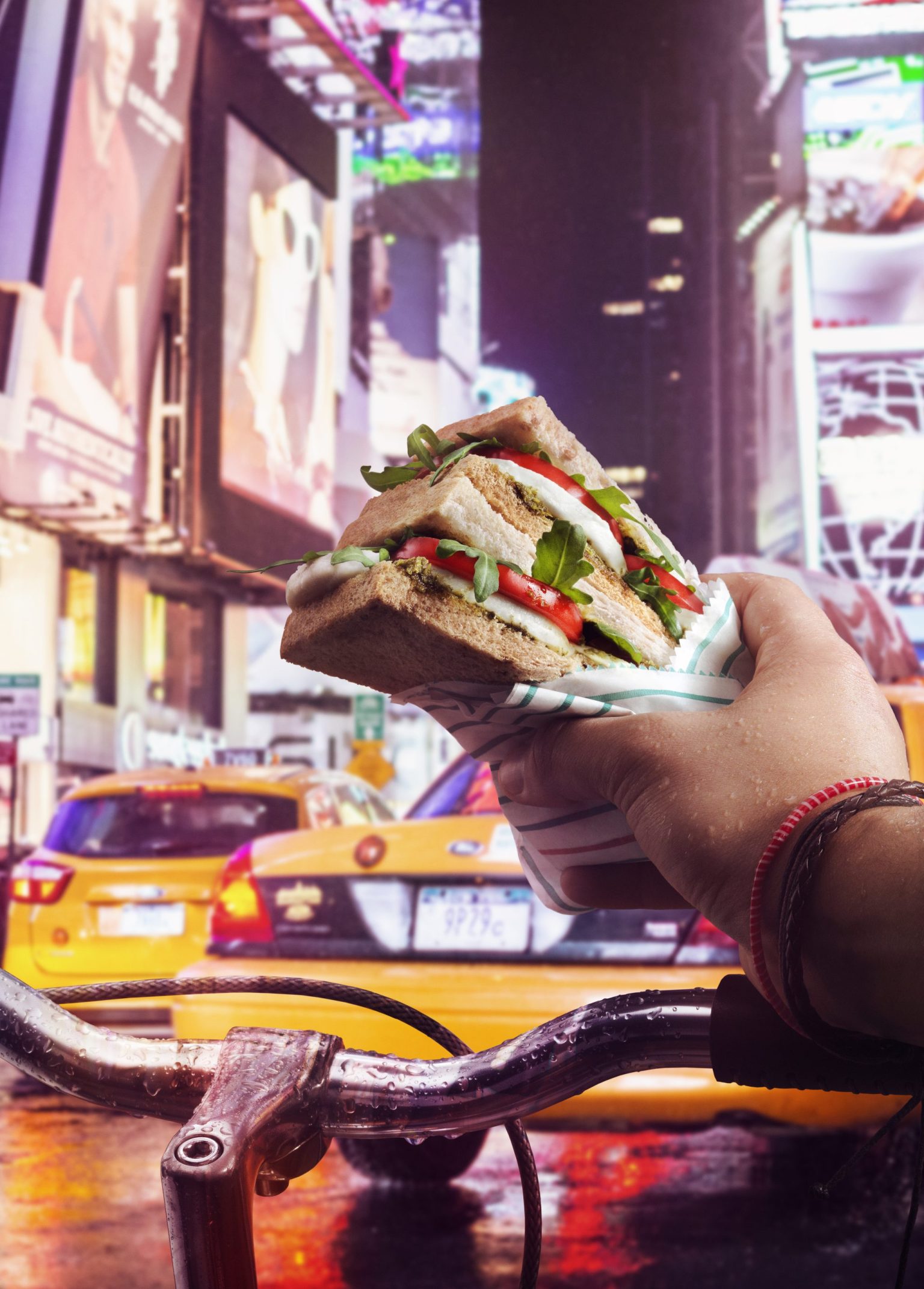 a hand holding a sandwich