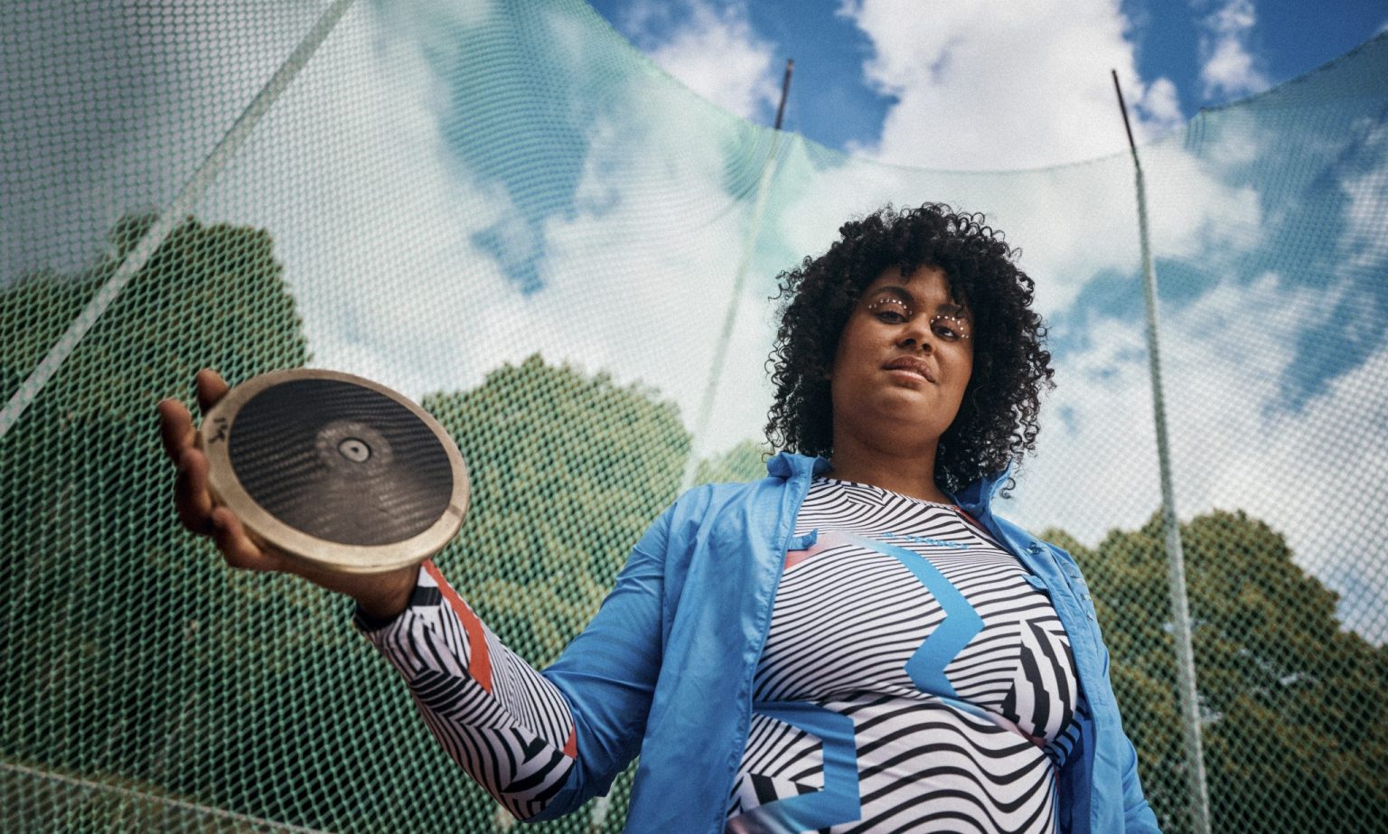 a woman holding a disc