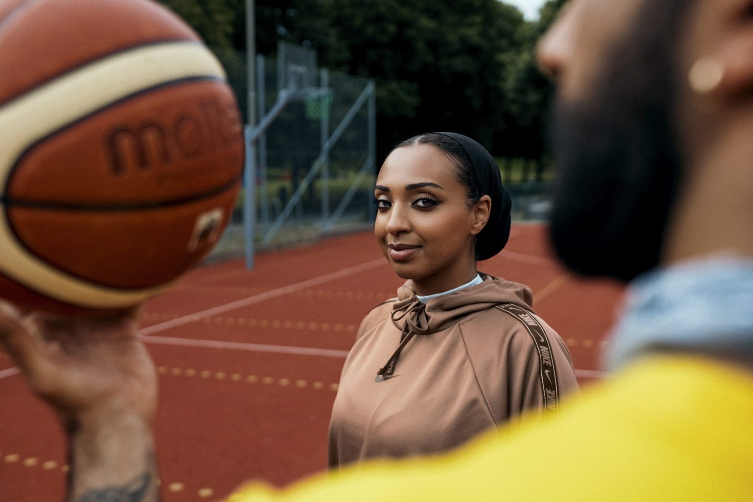 a woman holding a basketball