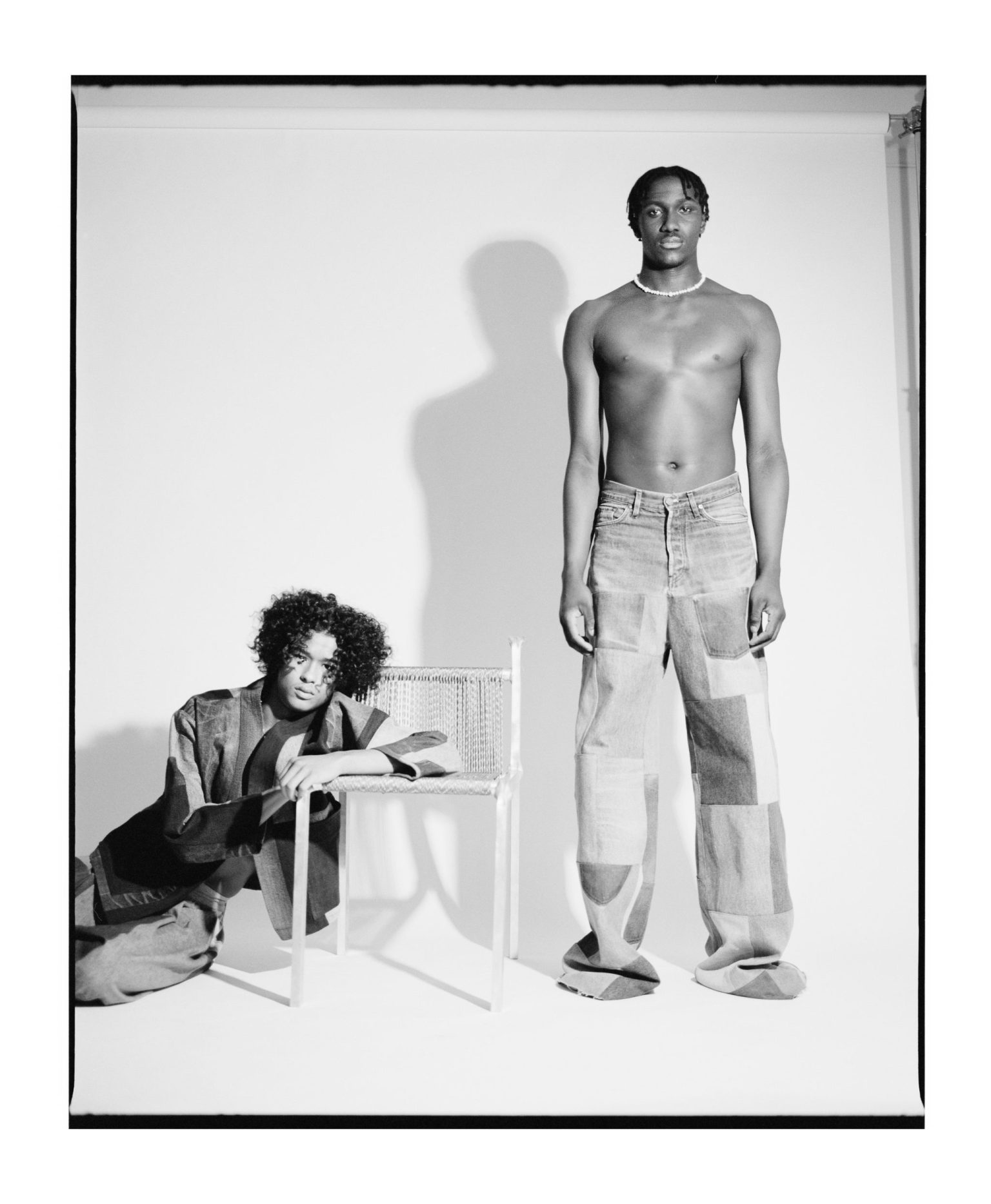 a man standing next to a person