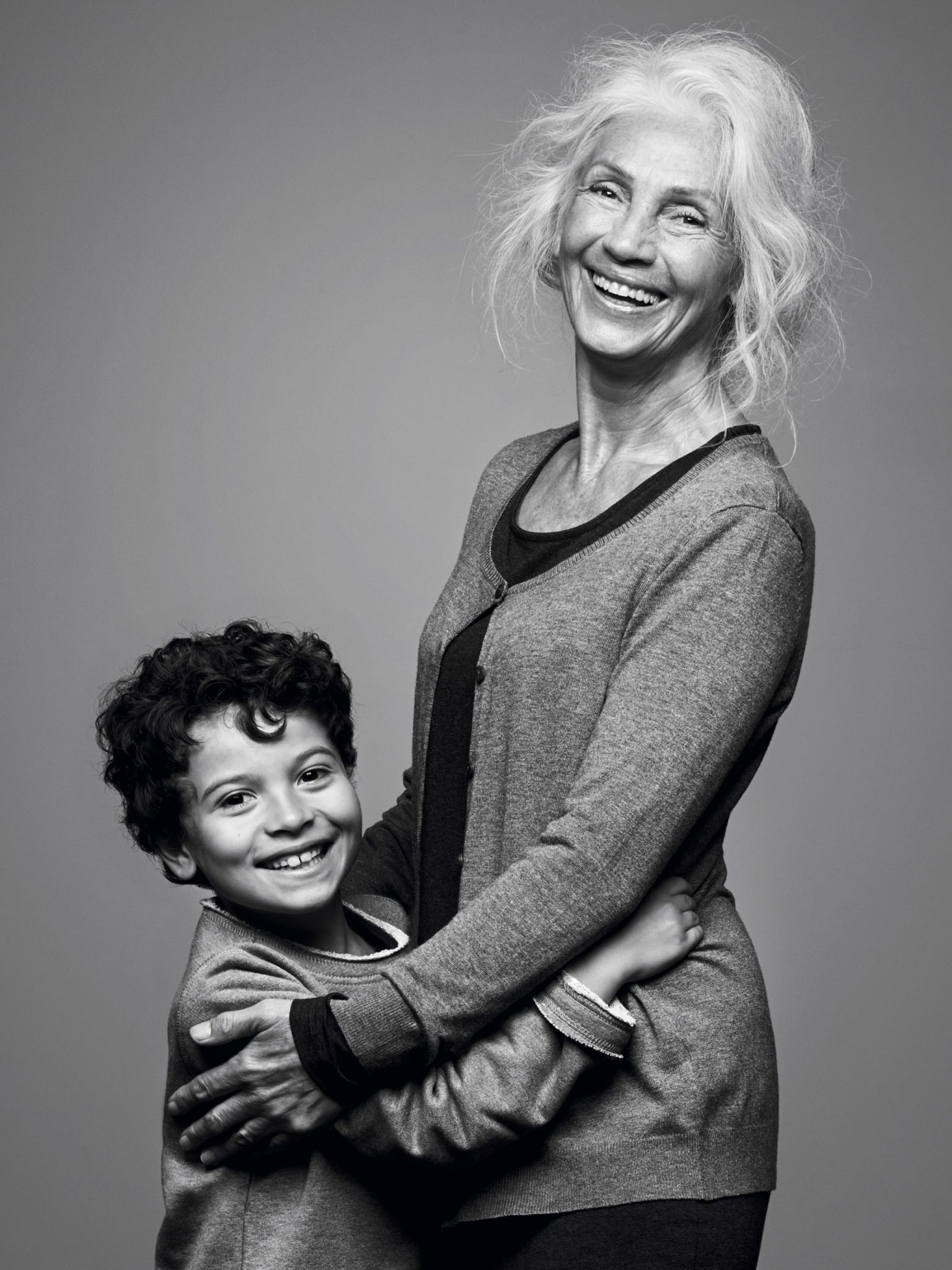 a woman holding a boy