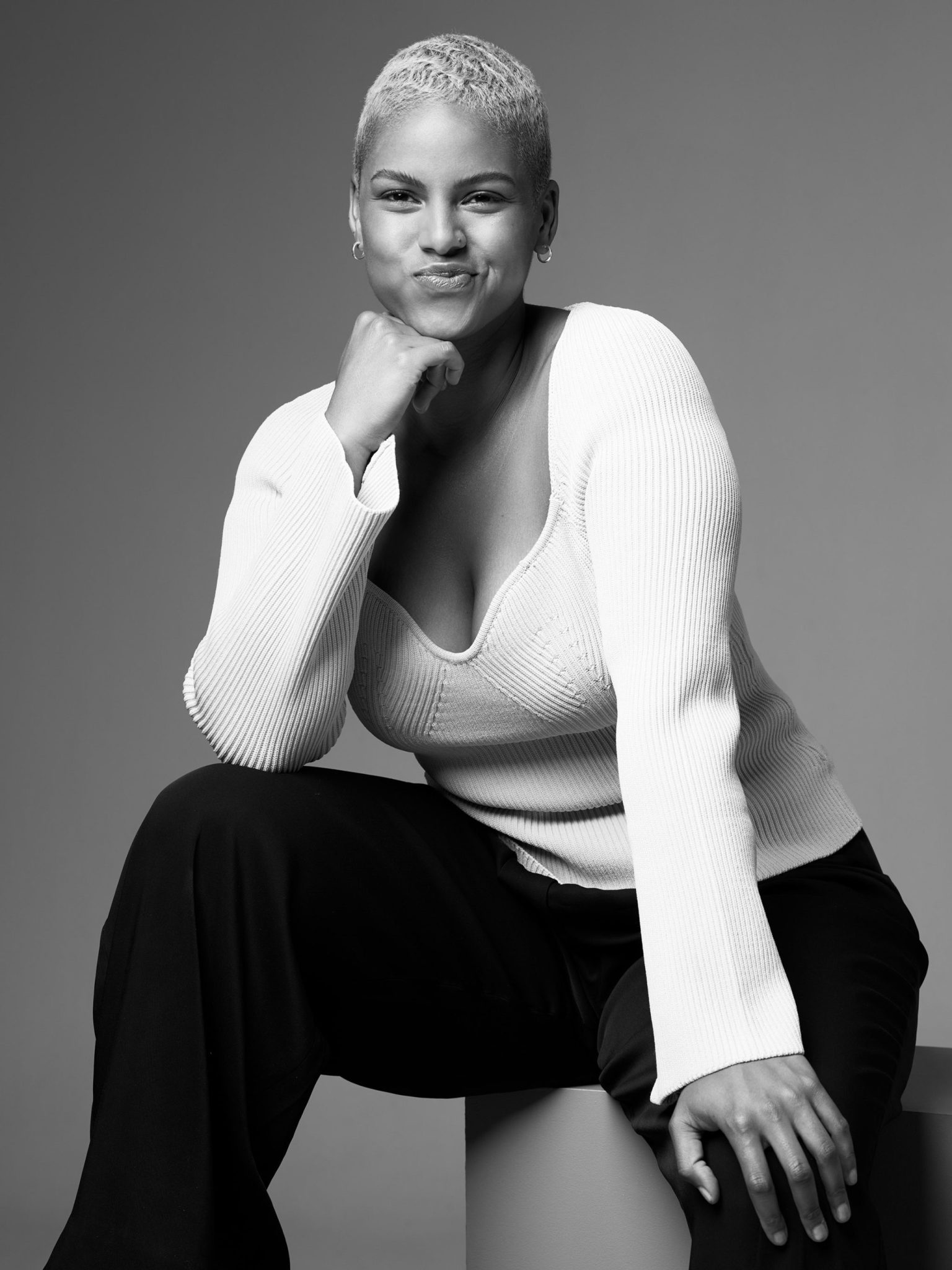 a woman sitting on a cube
