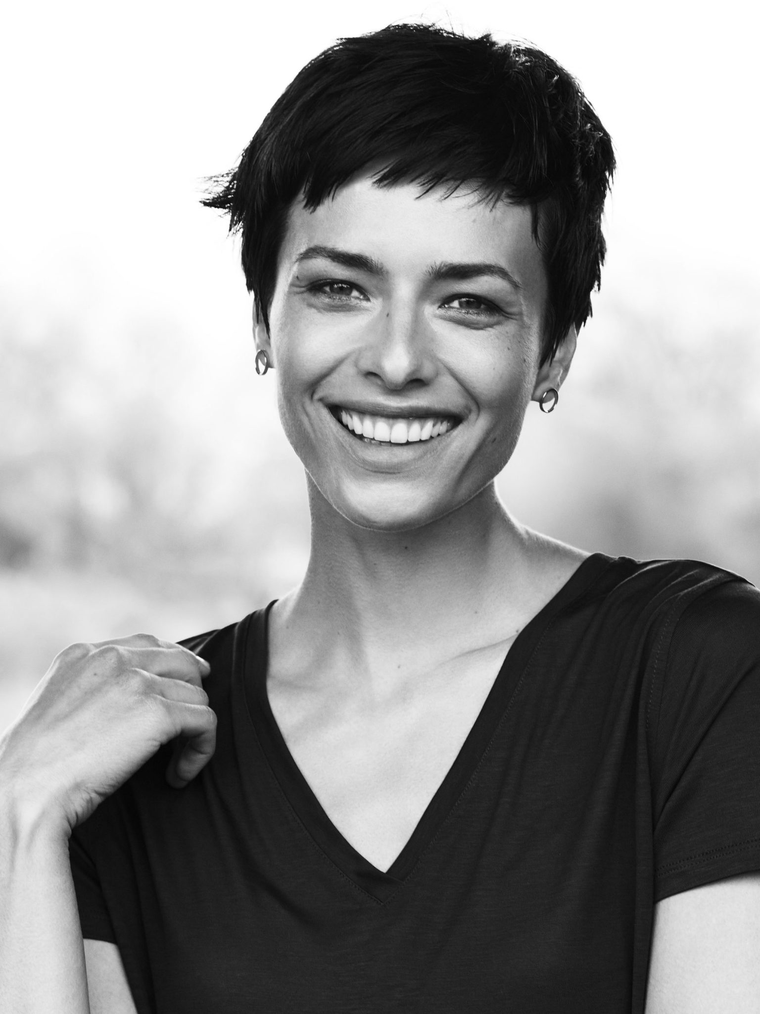 a woman smiling with short hair