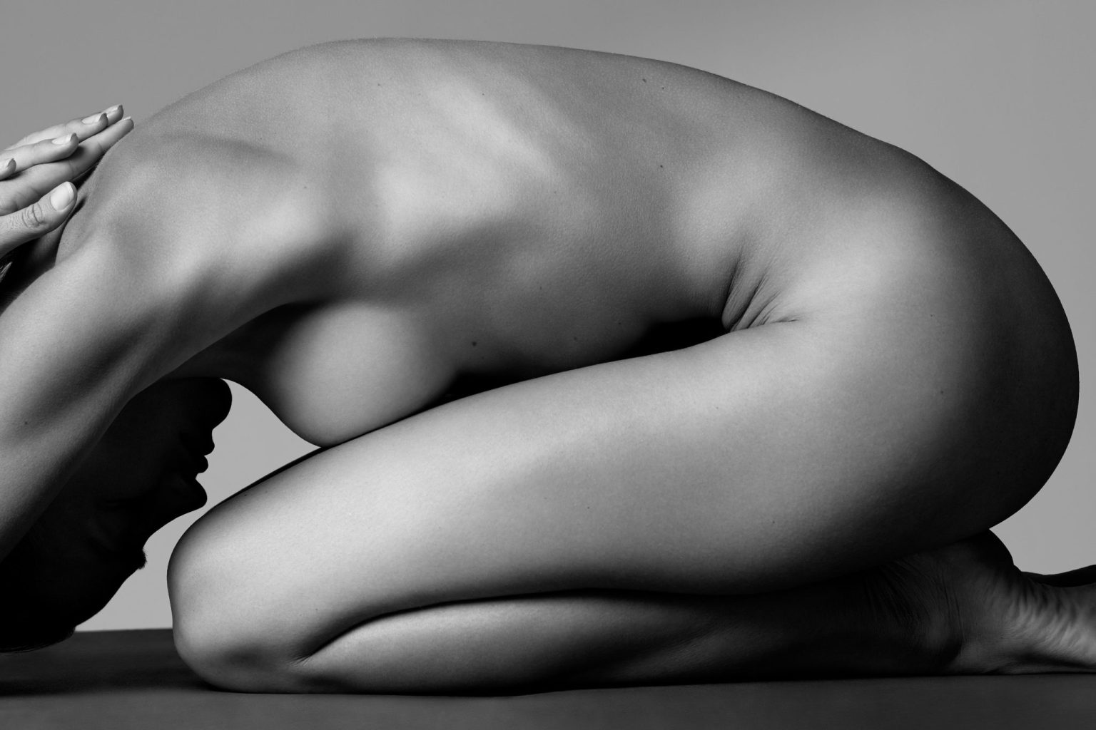 a naked woman kneeling on the floor