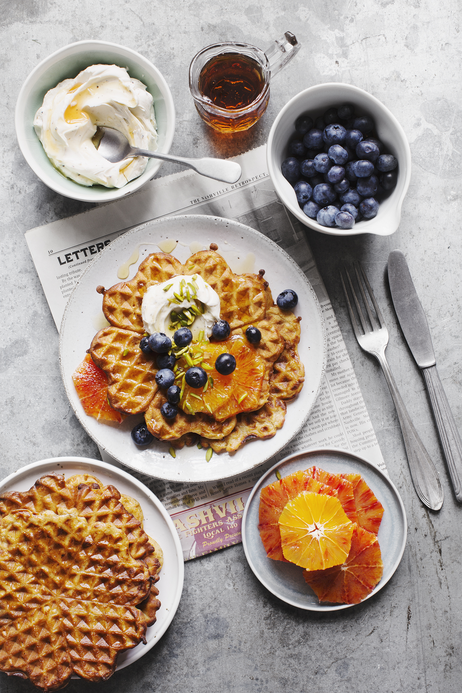 a plate of waffles and fruits
