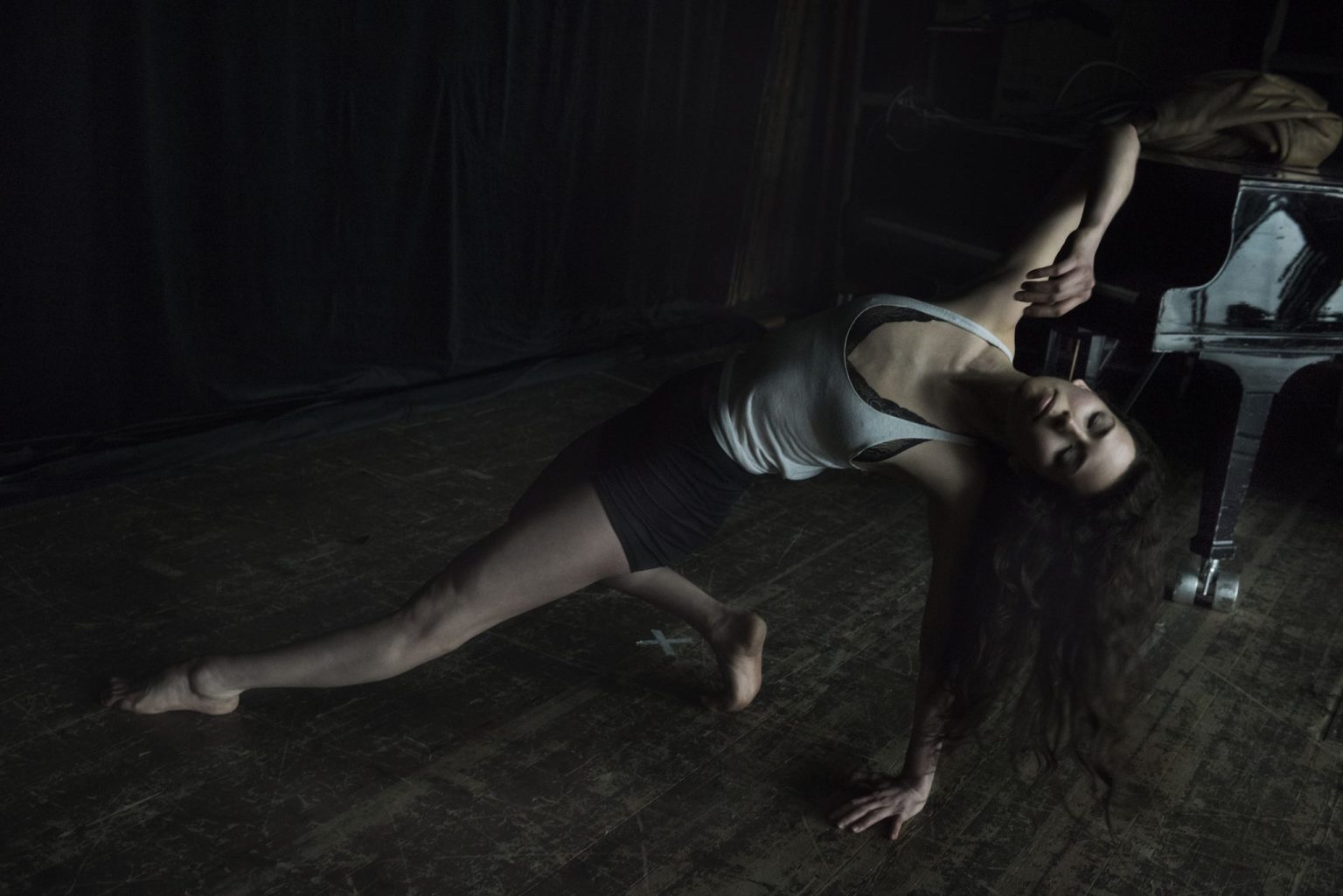 a woman stretching on a wooden floor