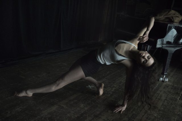 a woman stretching on a wooden floor