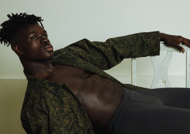 a man lying down with his shirt on