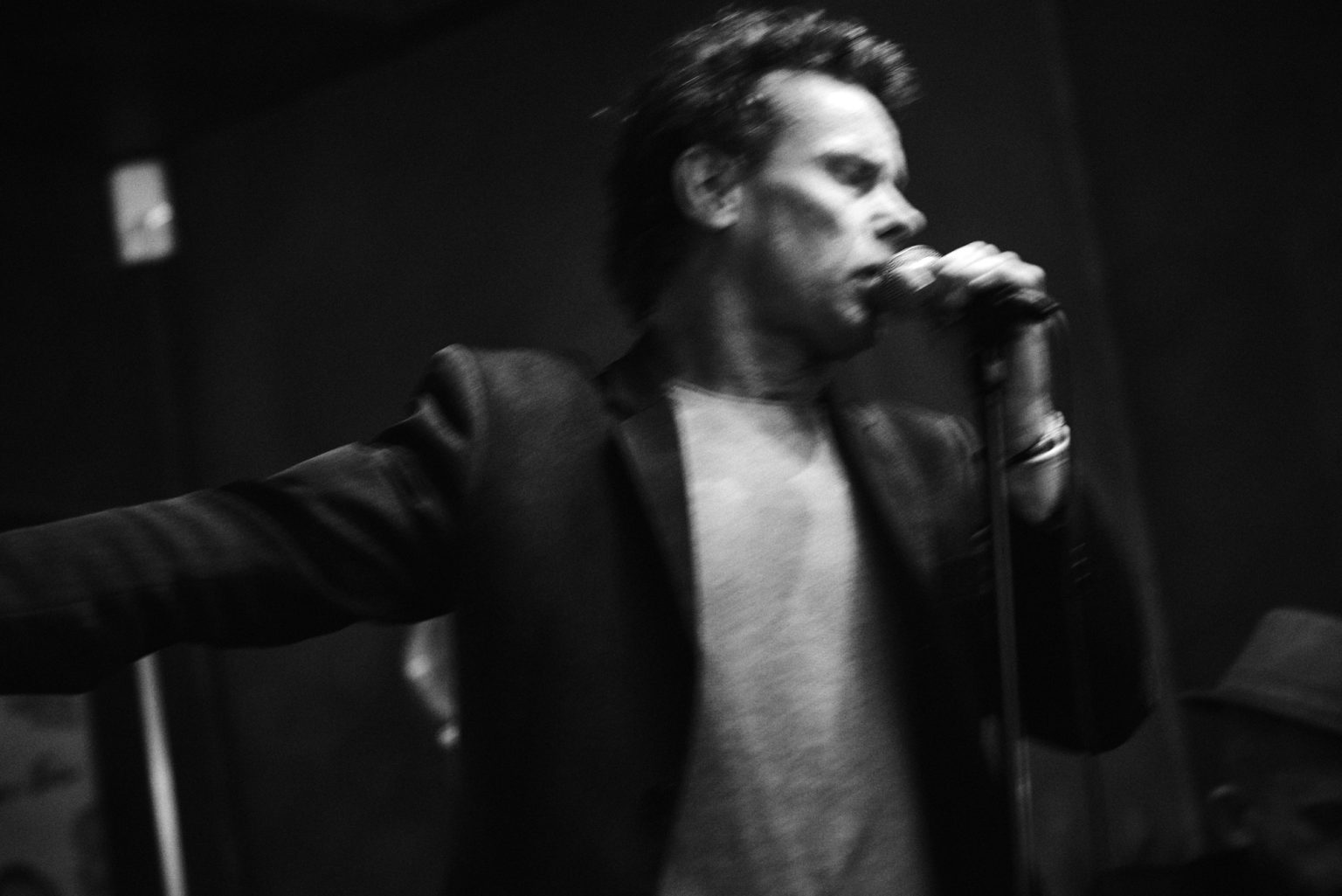 a man singing into a microphone