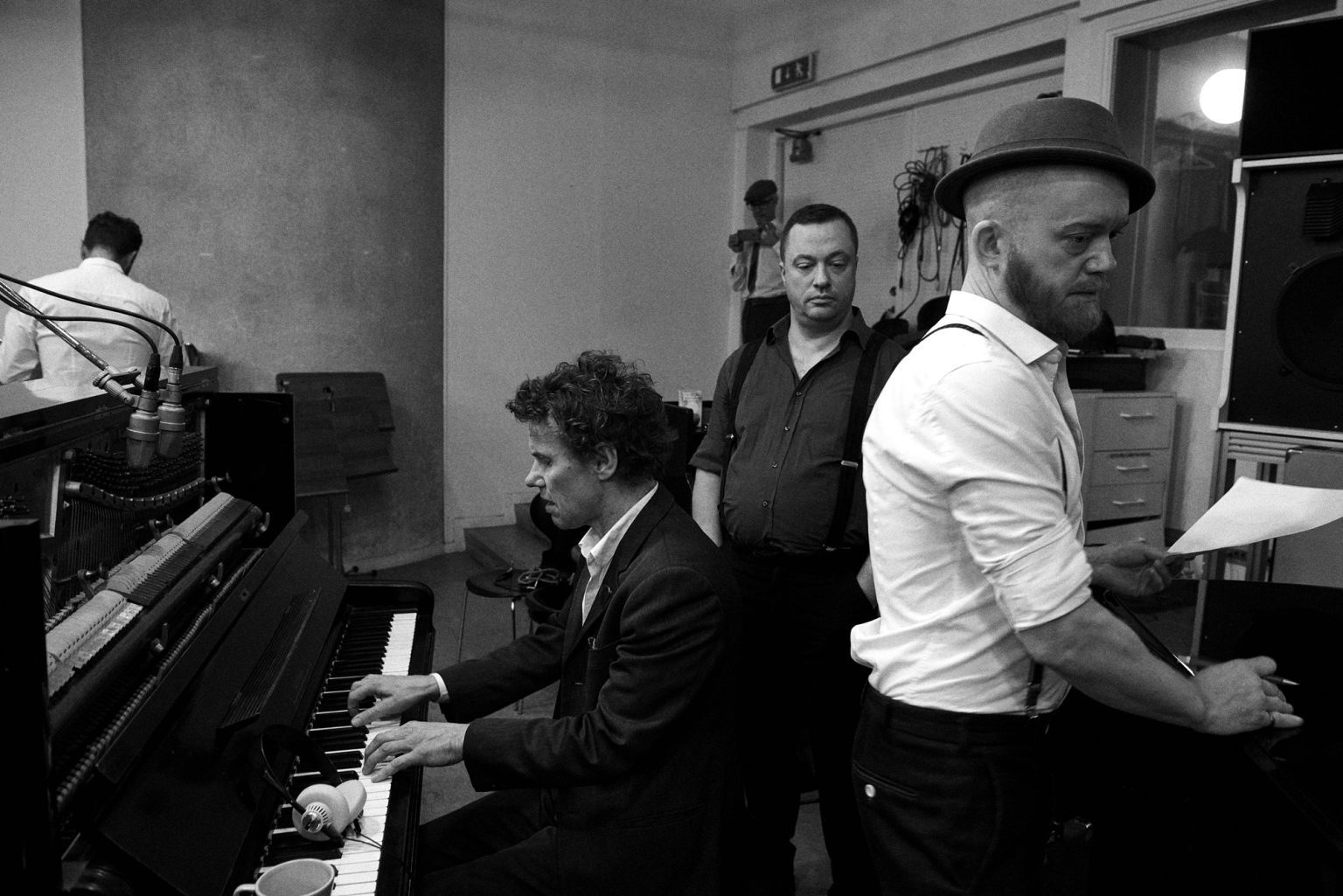 a group of men playing piano