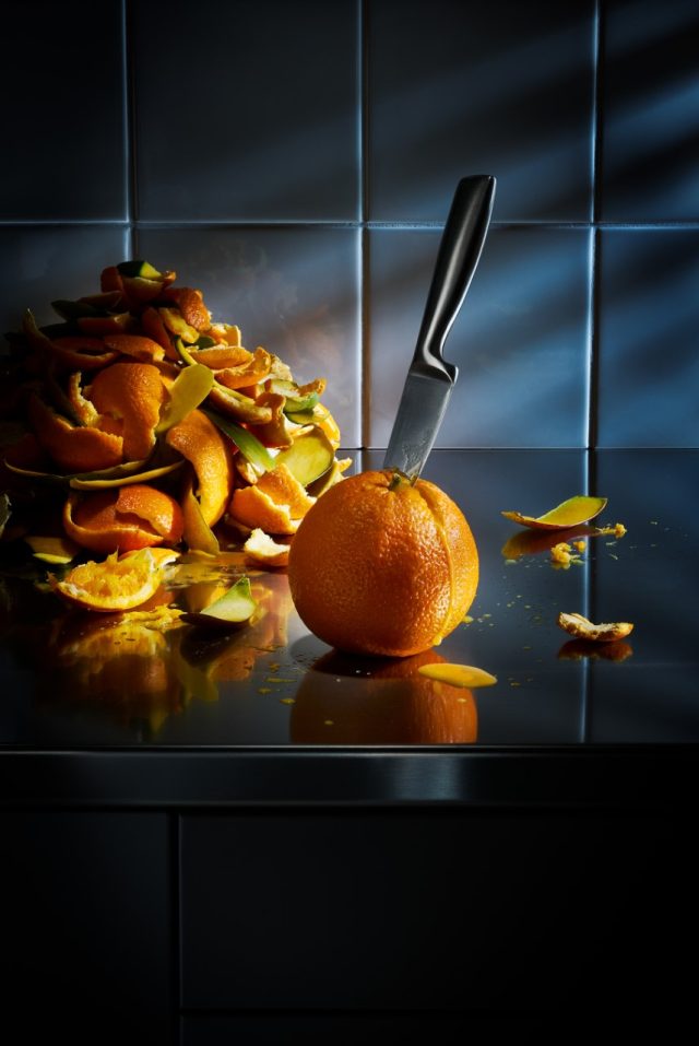 a knife on a peel of an orange