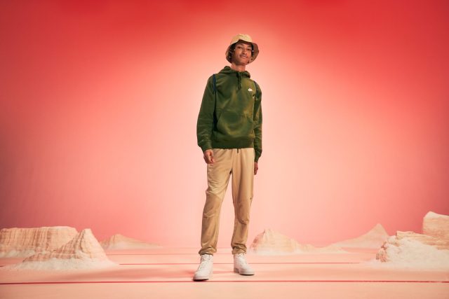 a man standing in front of a red background