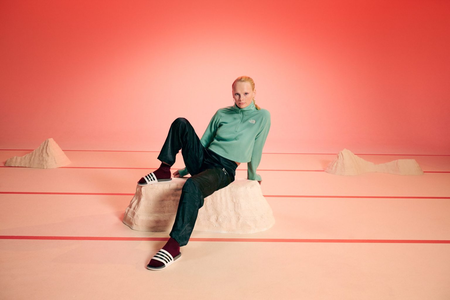 a woman sitting on a rock