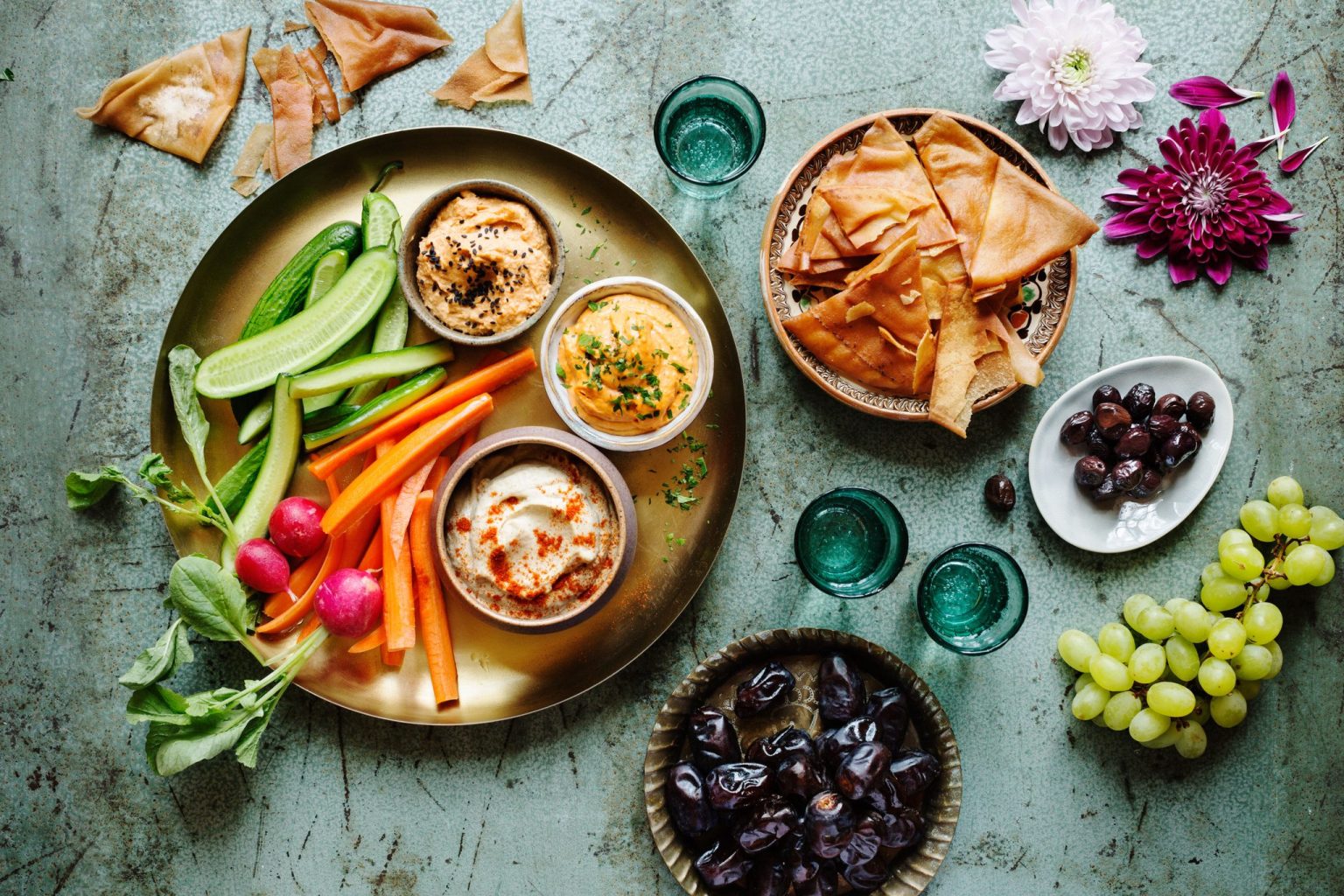 a plate of food and glasses on a table