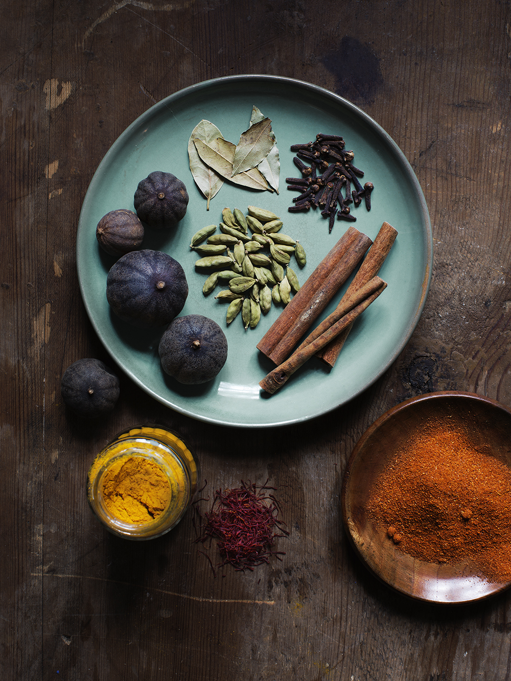 a plate with spices and herbs on it