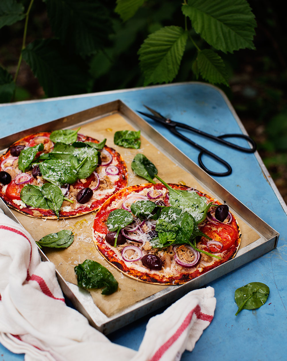 a pizzas with vegetables and cheese on a tray