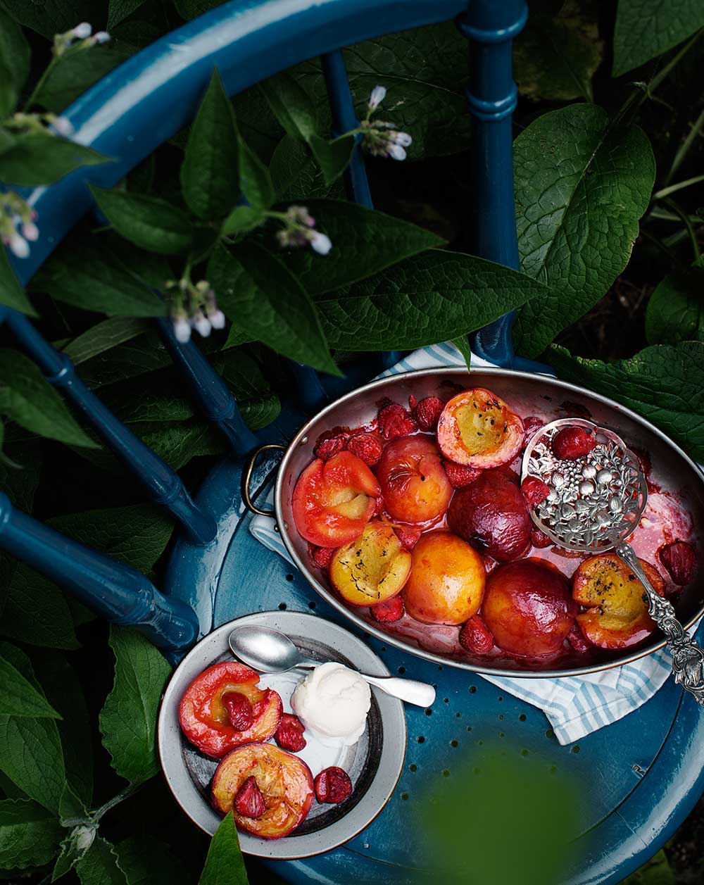 a bowl of fruit and ice cream on a blue chair