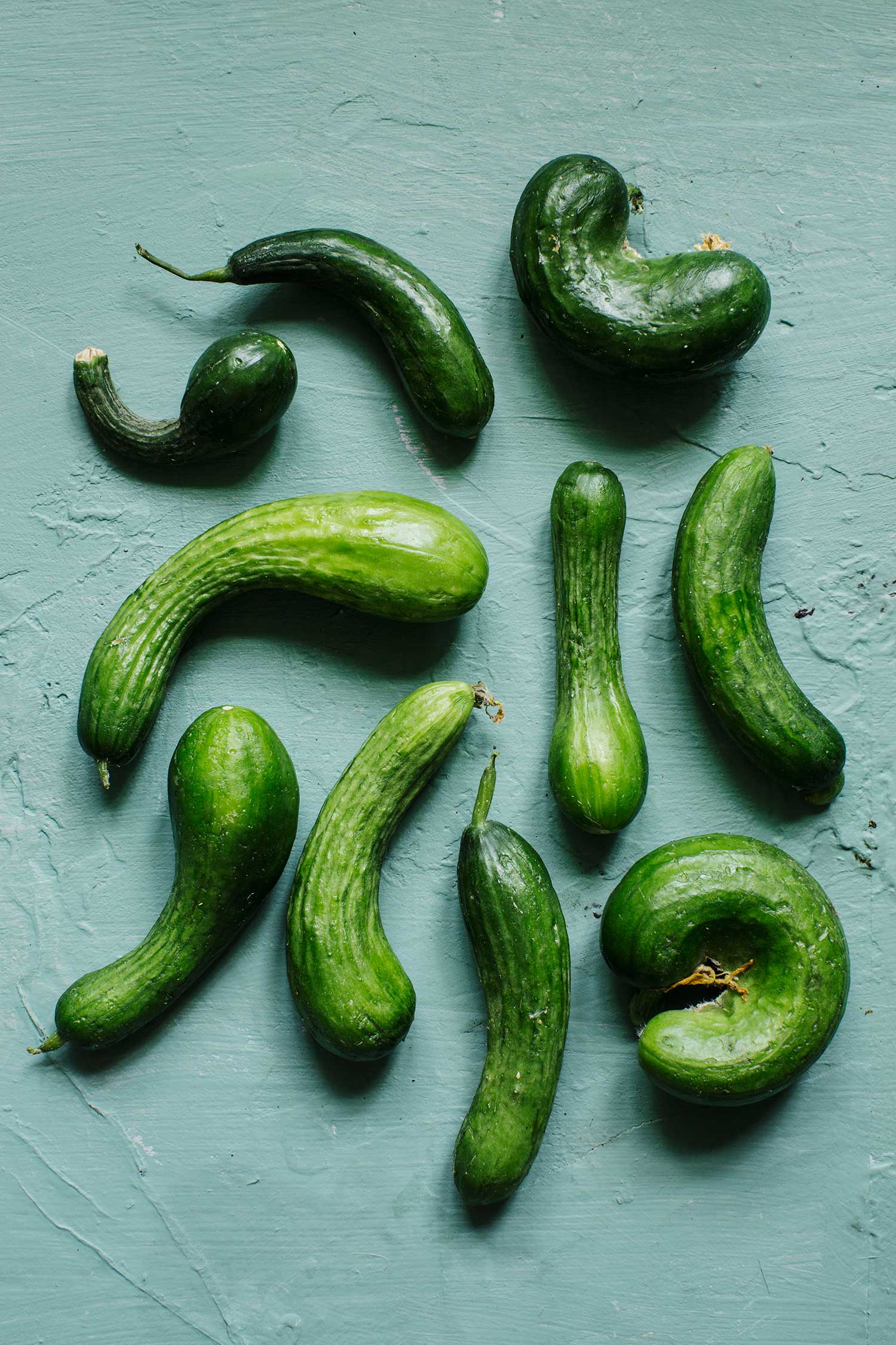 a group of cucumbers on a blue surface