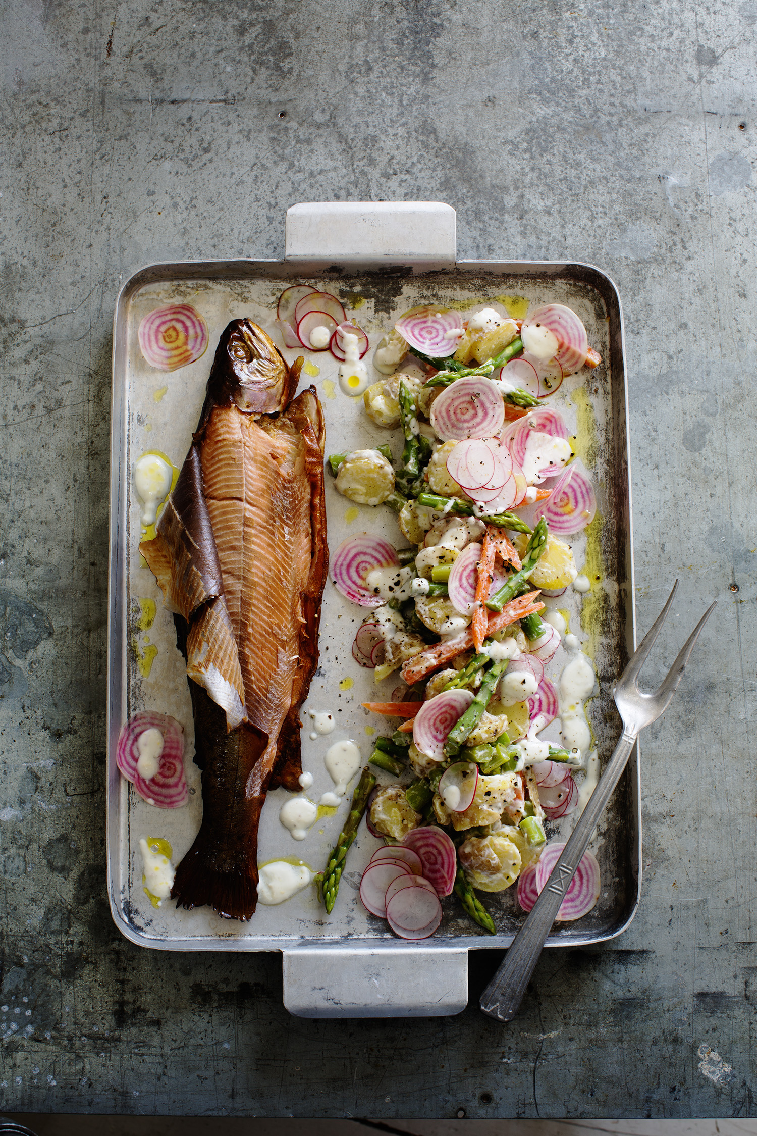 a fish and vegetables on a tray
