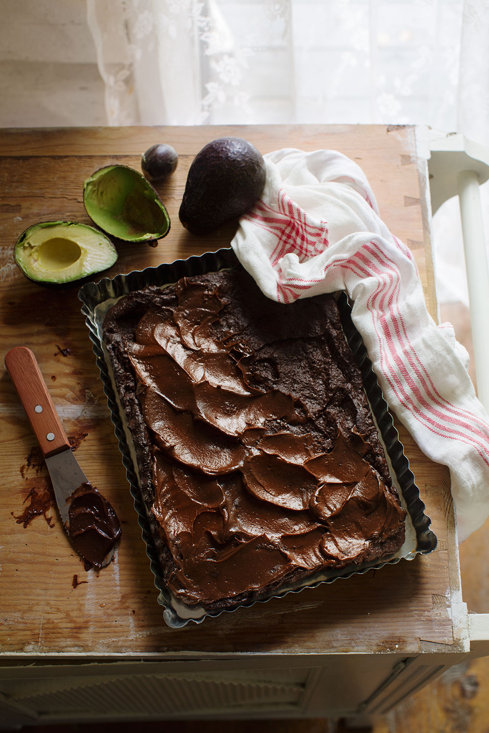 a brownie with chocolate frosting and avocado