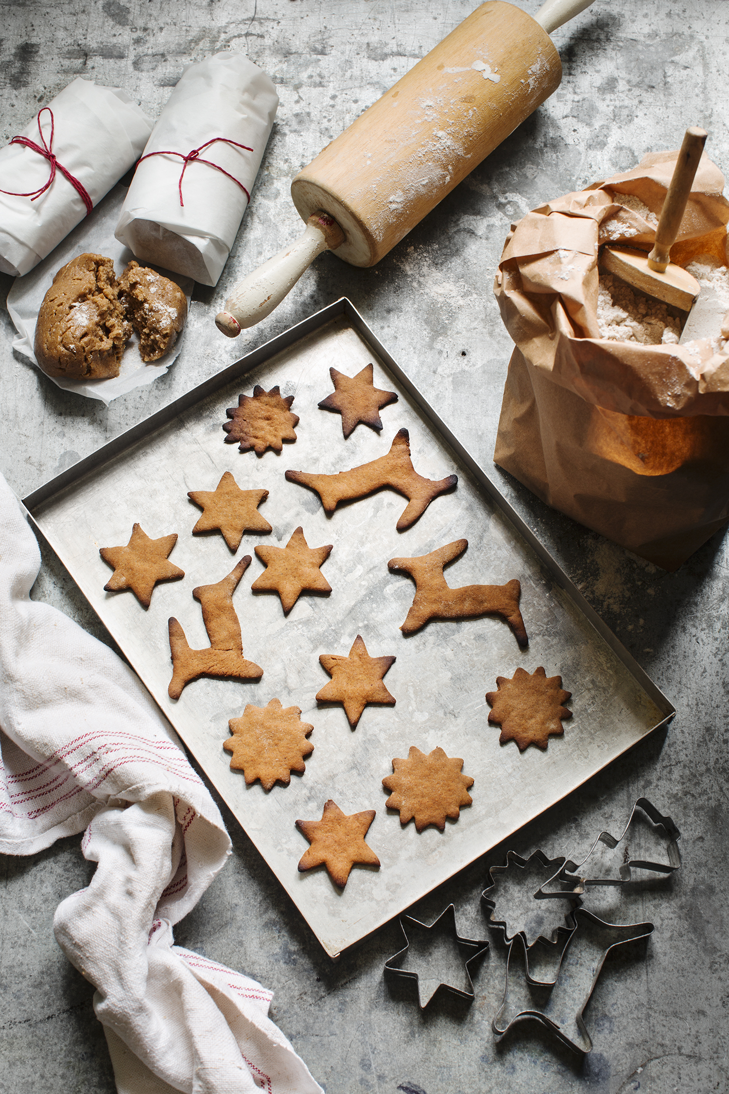 a tray of cookies and rolling pin