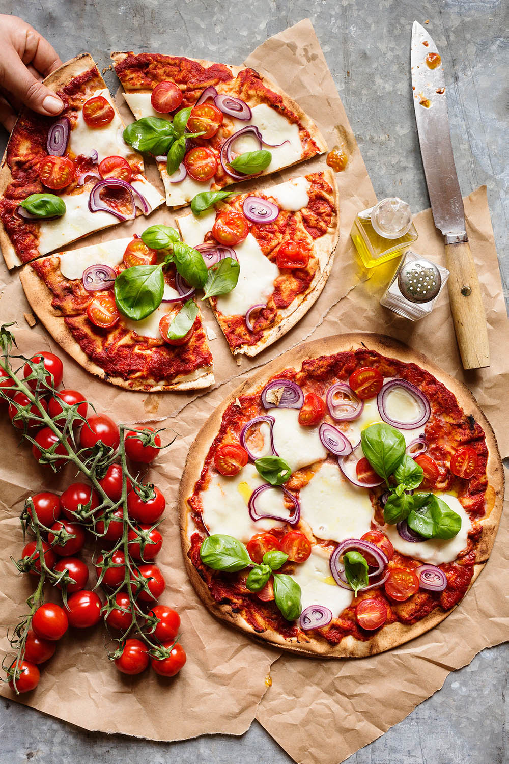 a pizza with tomatoes and onions on a table