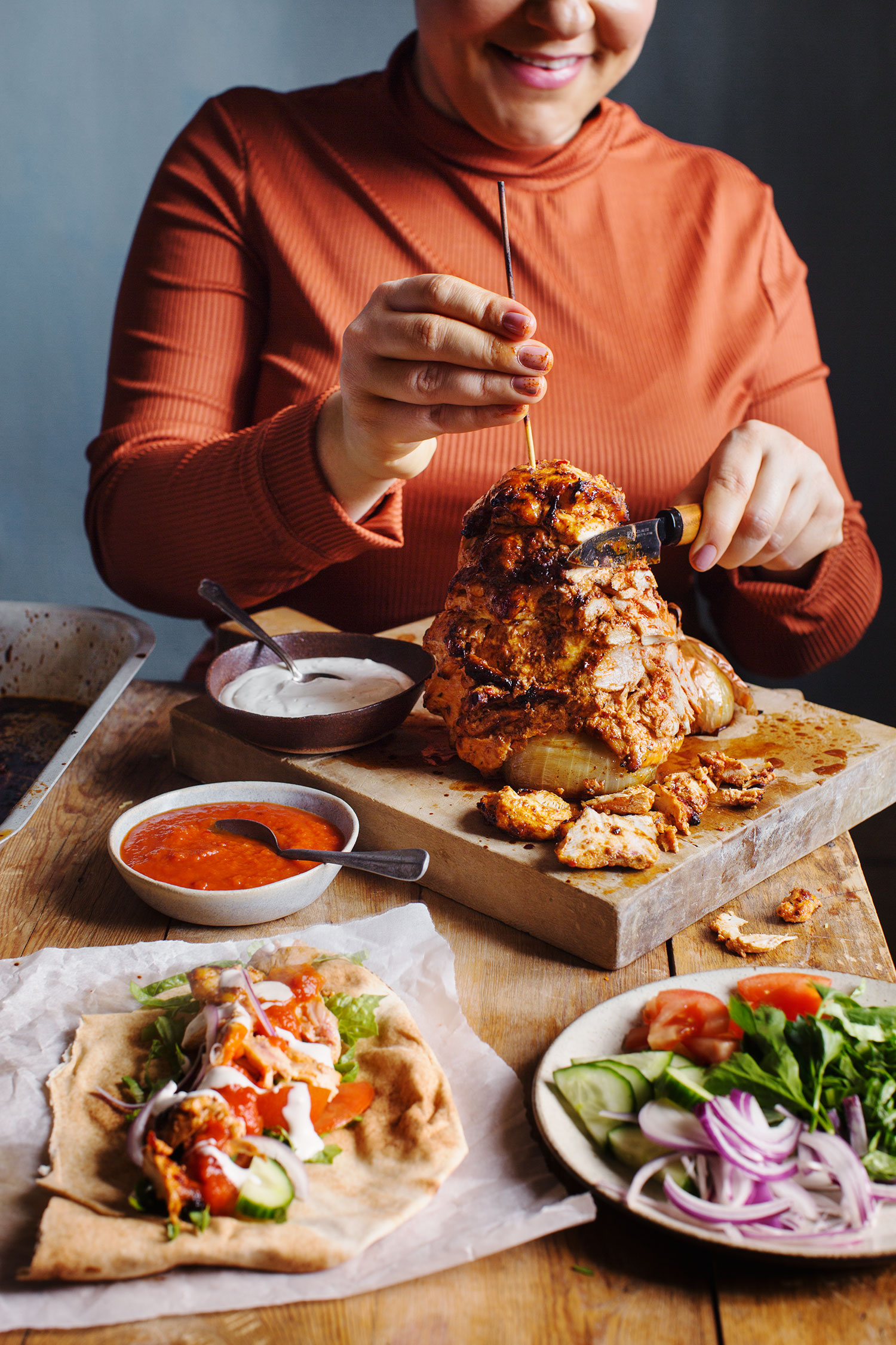 a person cutting food on a cutting board