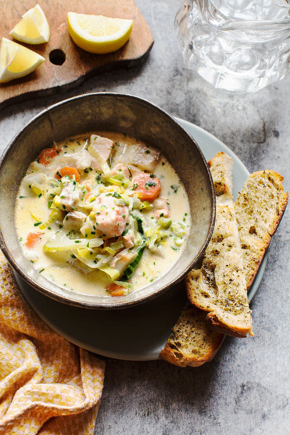 a bowl of soup with bread on a plate