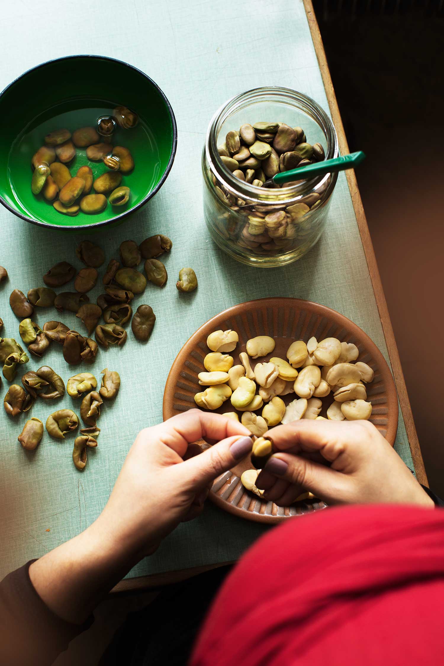 a person holding a bean on a plate