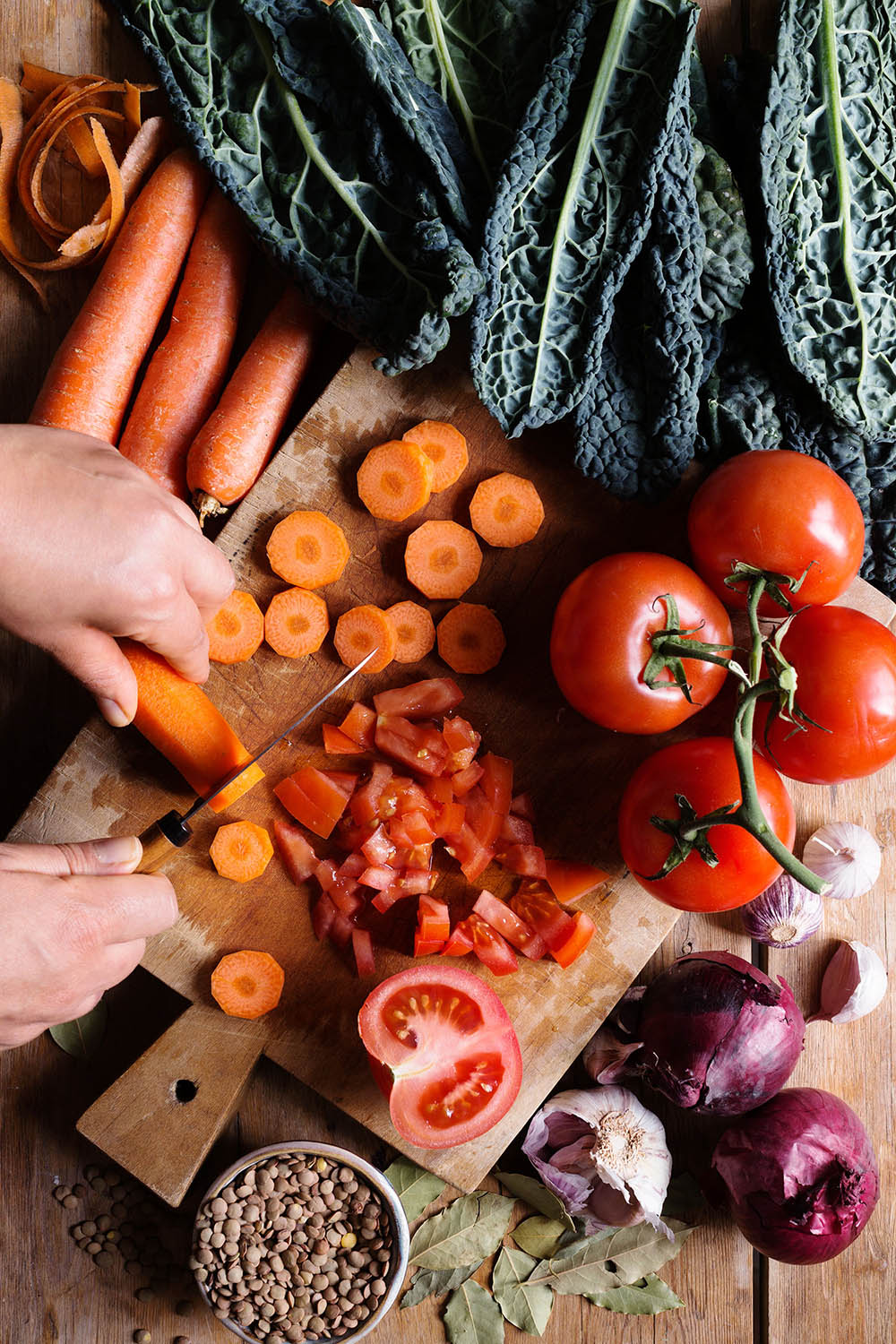 a person cutting vegetables on a cutting board