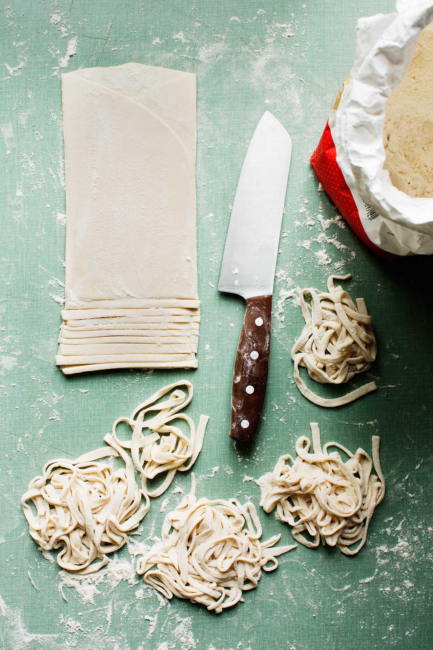 a knife and noodles on a table