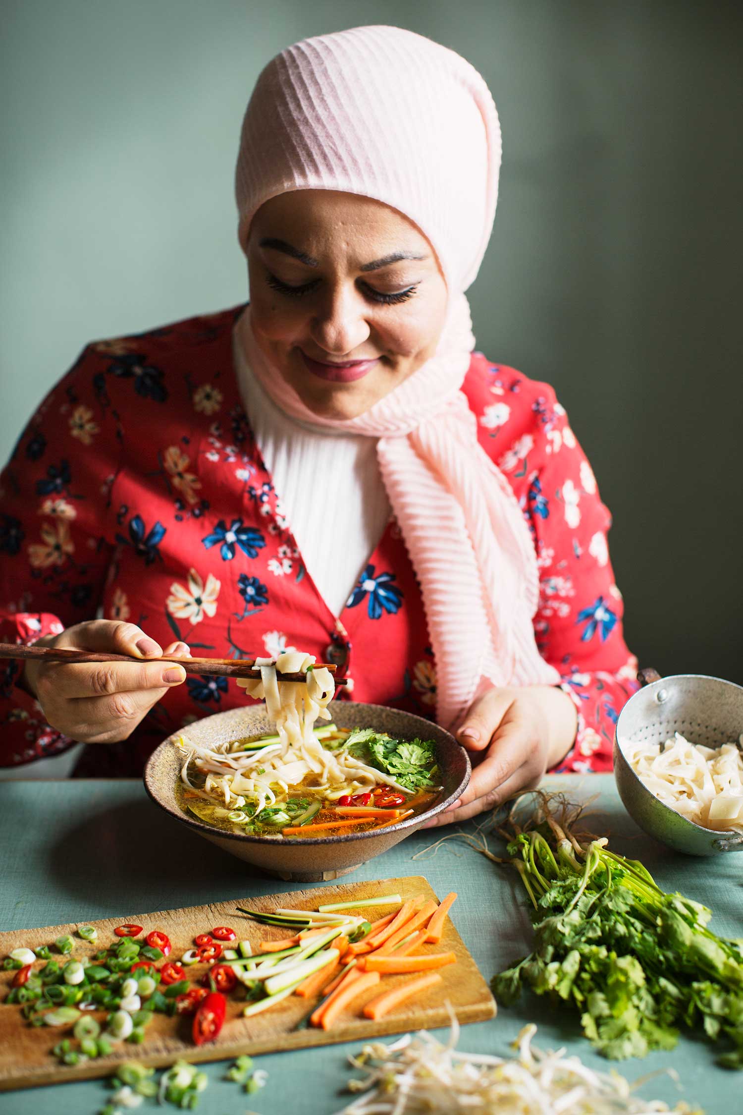 a woman eating food with chopsticks