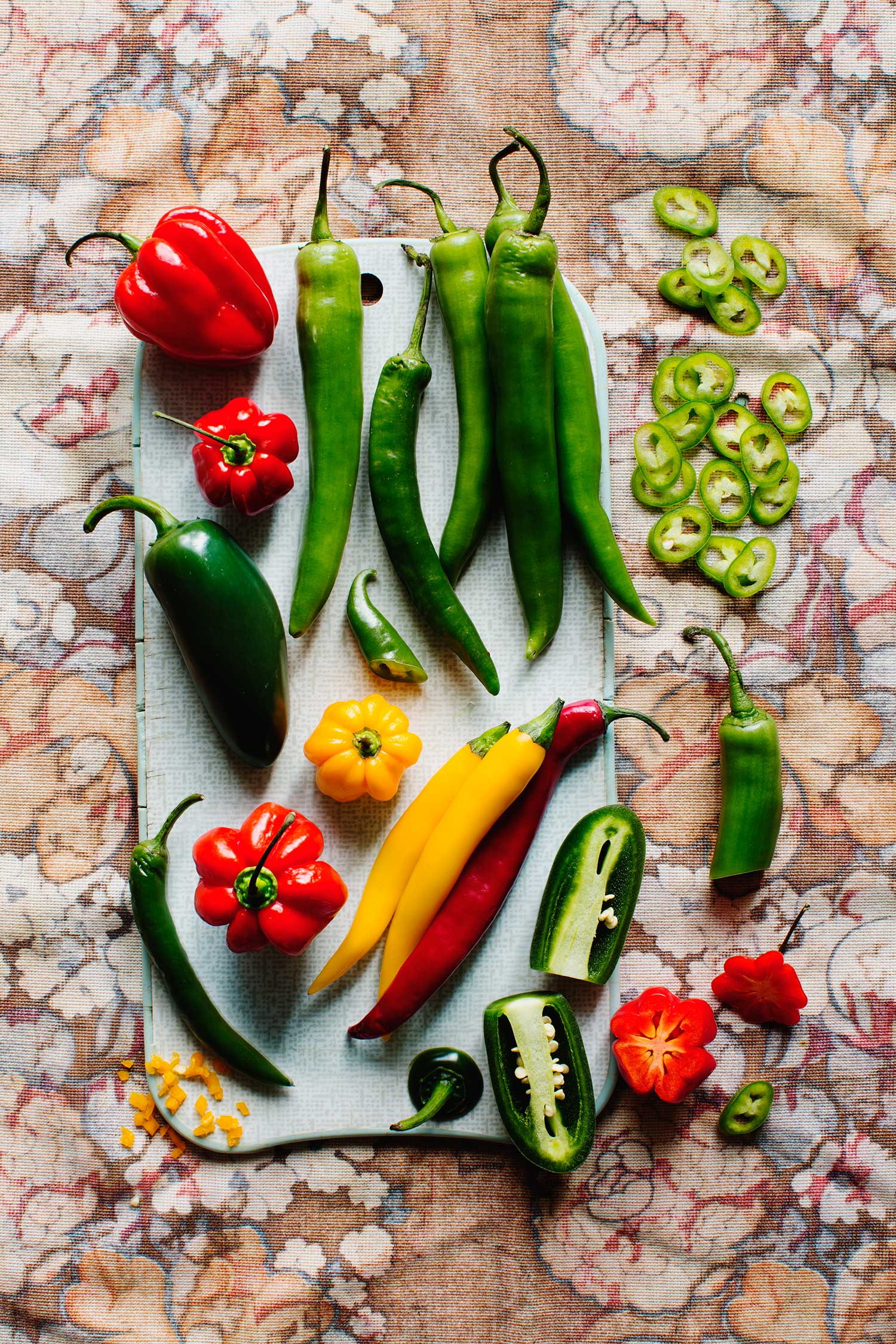 a group of peppers on a cutting board