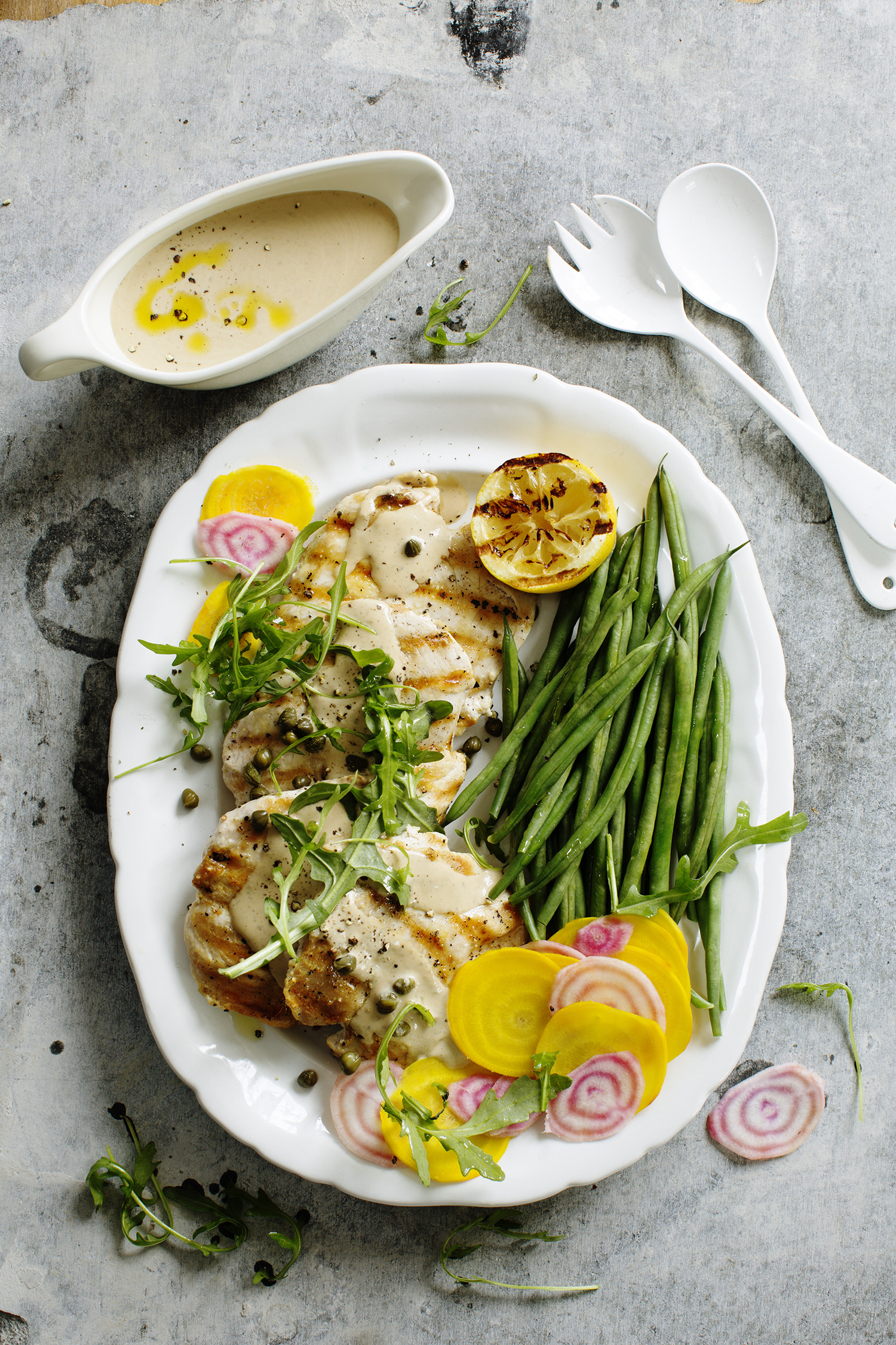 a plate of food with sauce and spoons