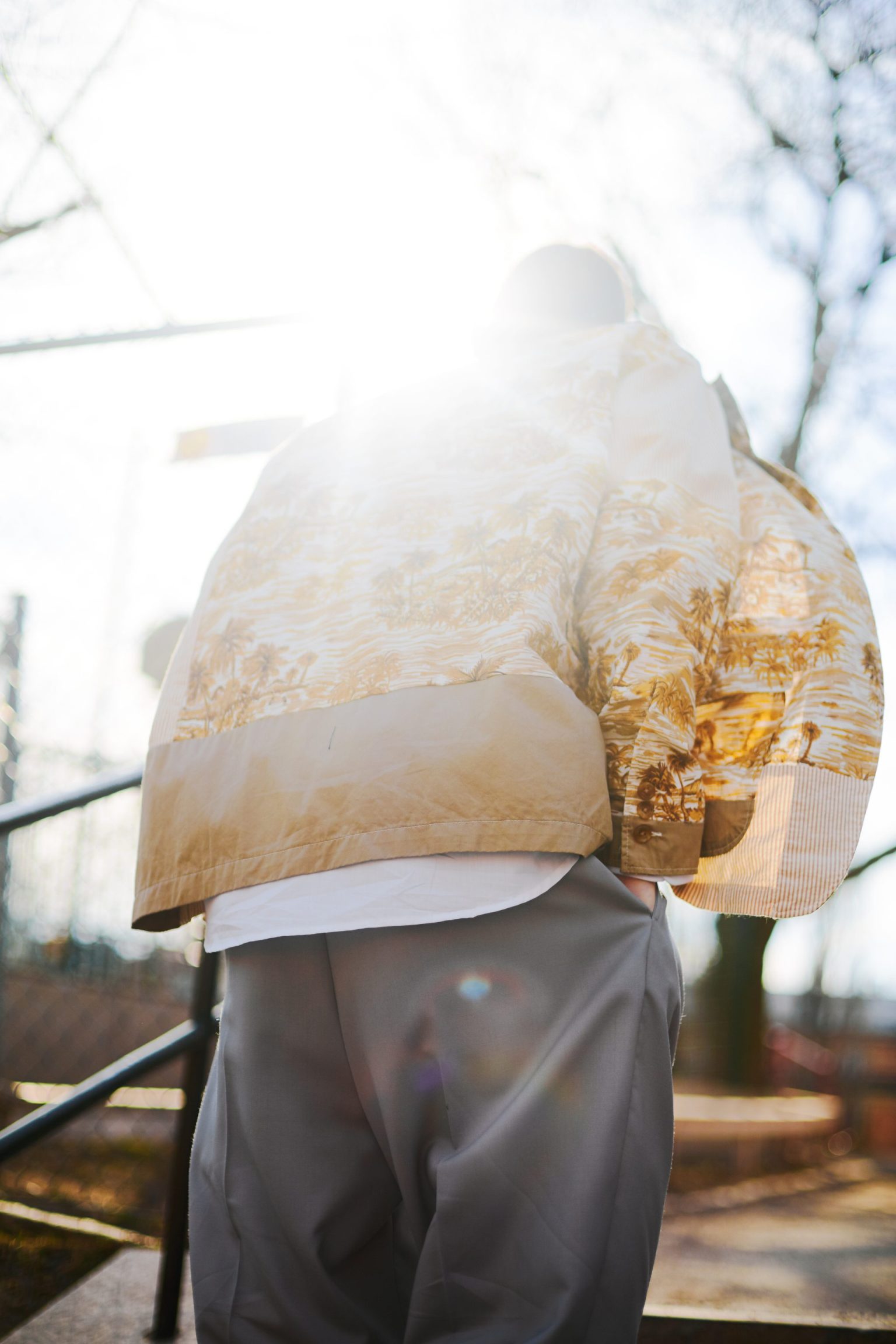 a person standing outside with their back turned