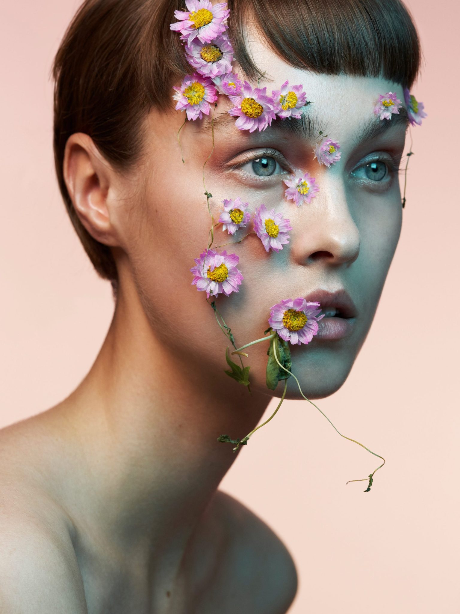 a woman with flowers on her face