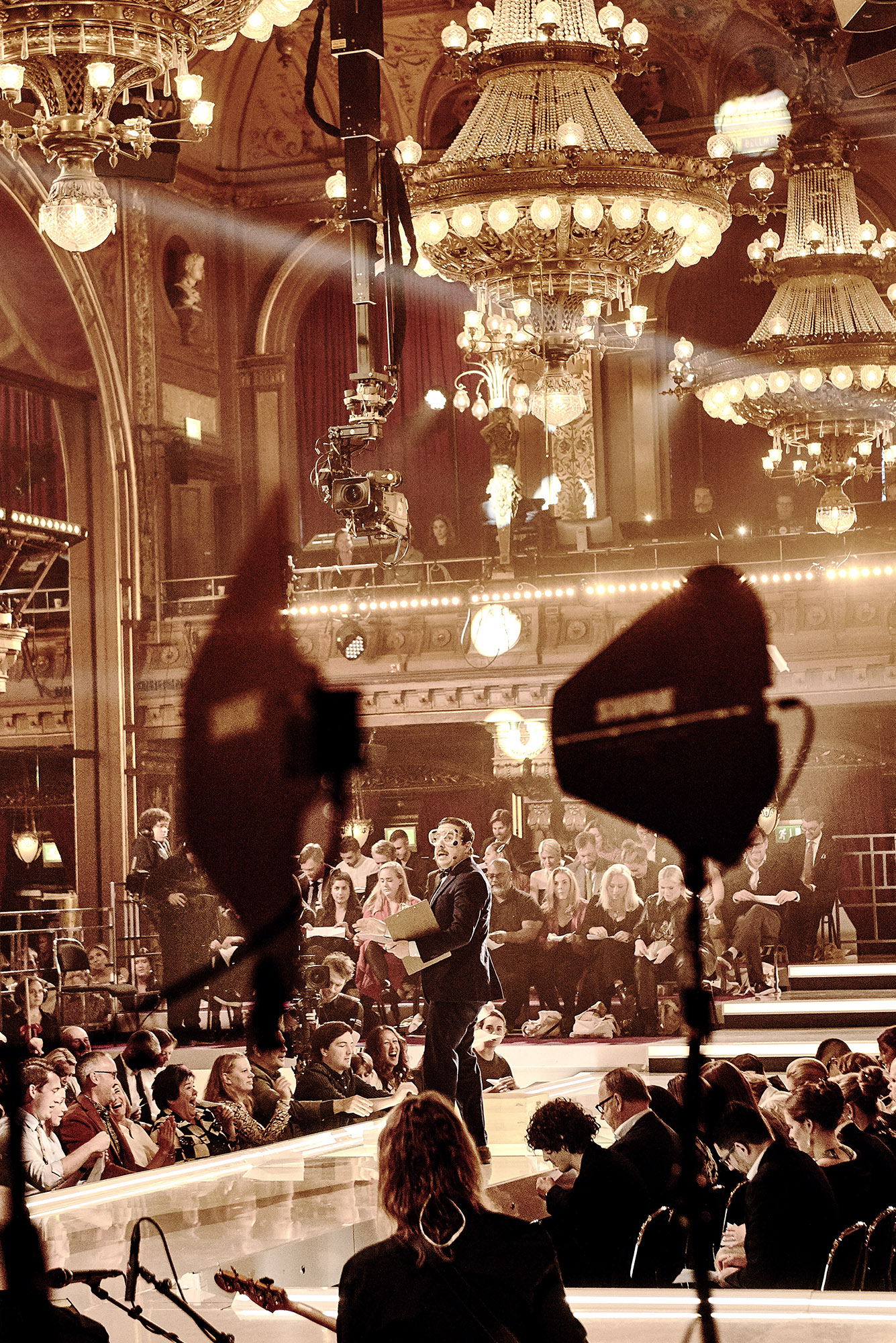 a man on a stage with a crowd of people