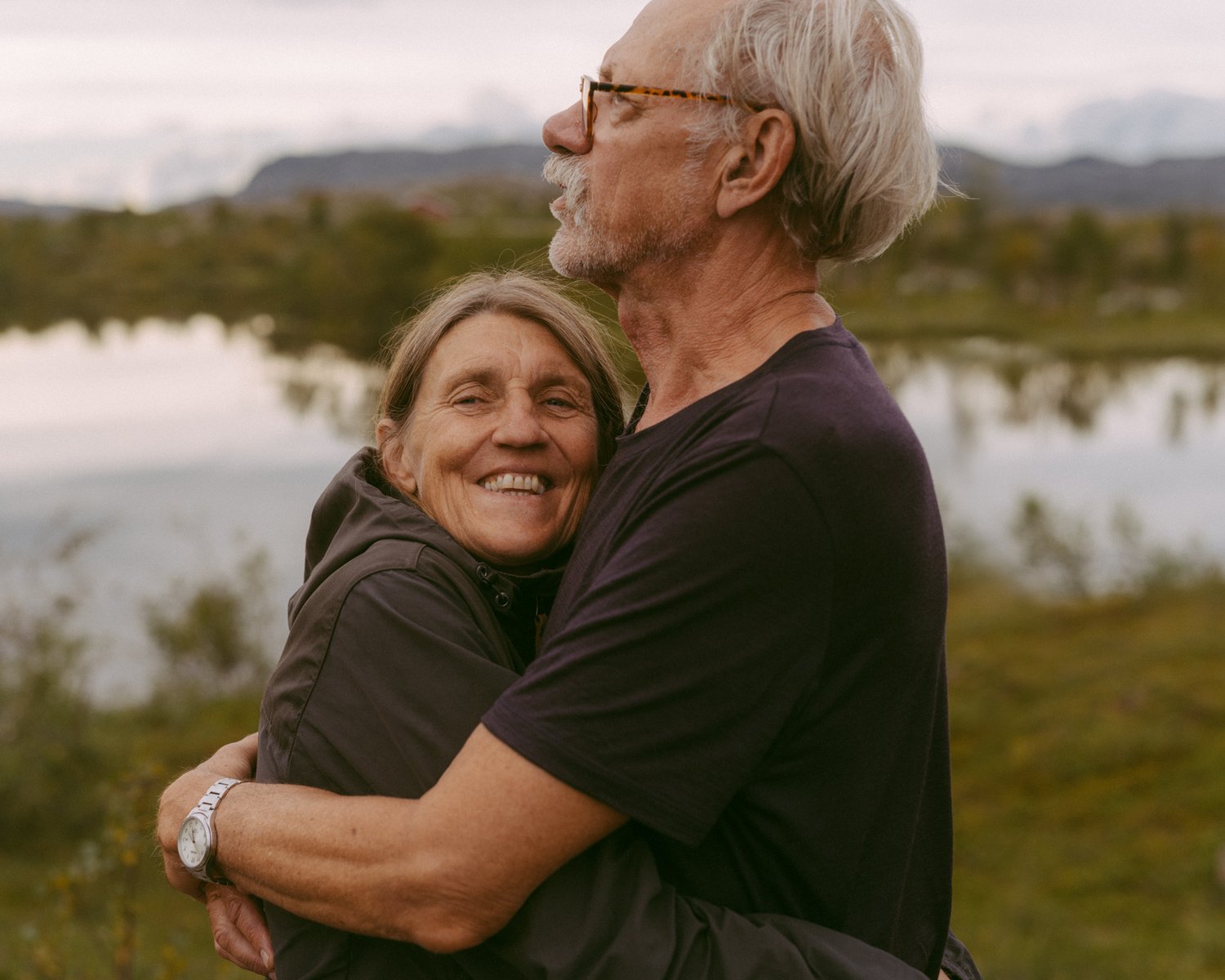 a man and woman hugging outside