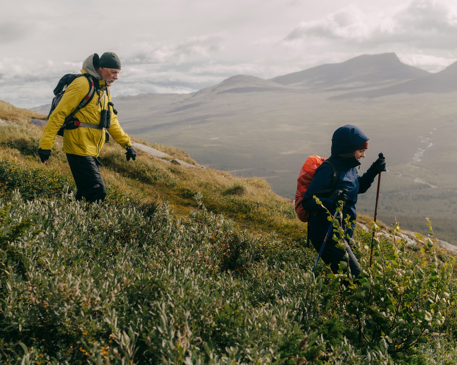 a man and woman hiking on a mountain