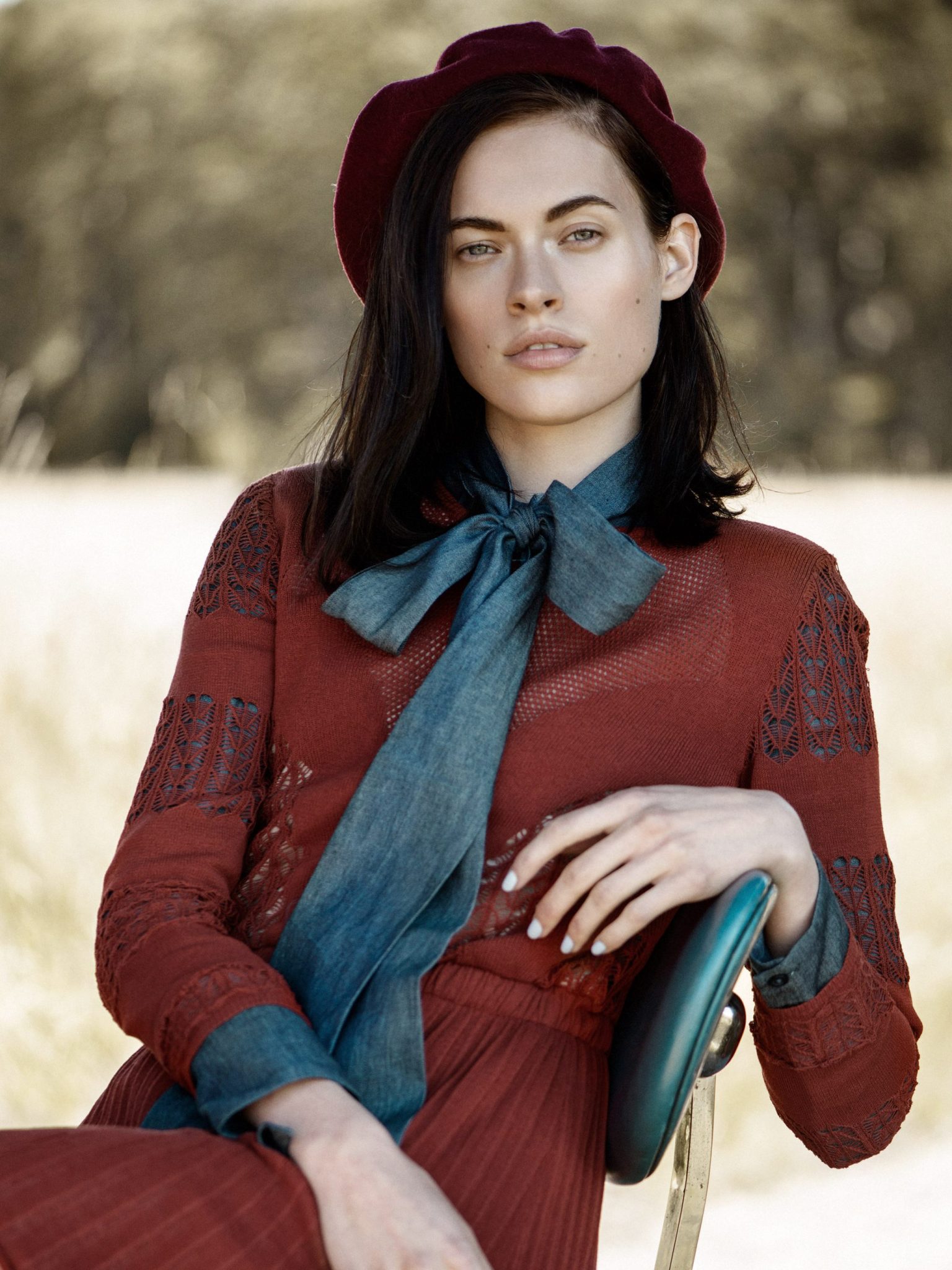 a woman in a red dress and hat