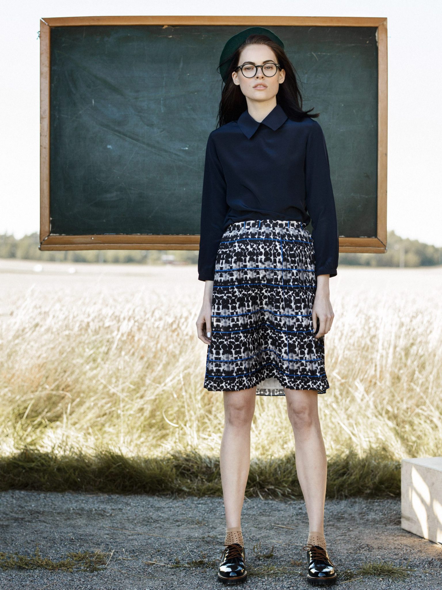 a woman standing in front of a chalkboard