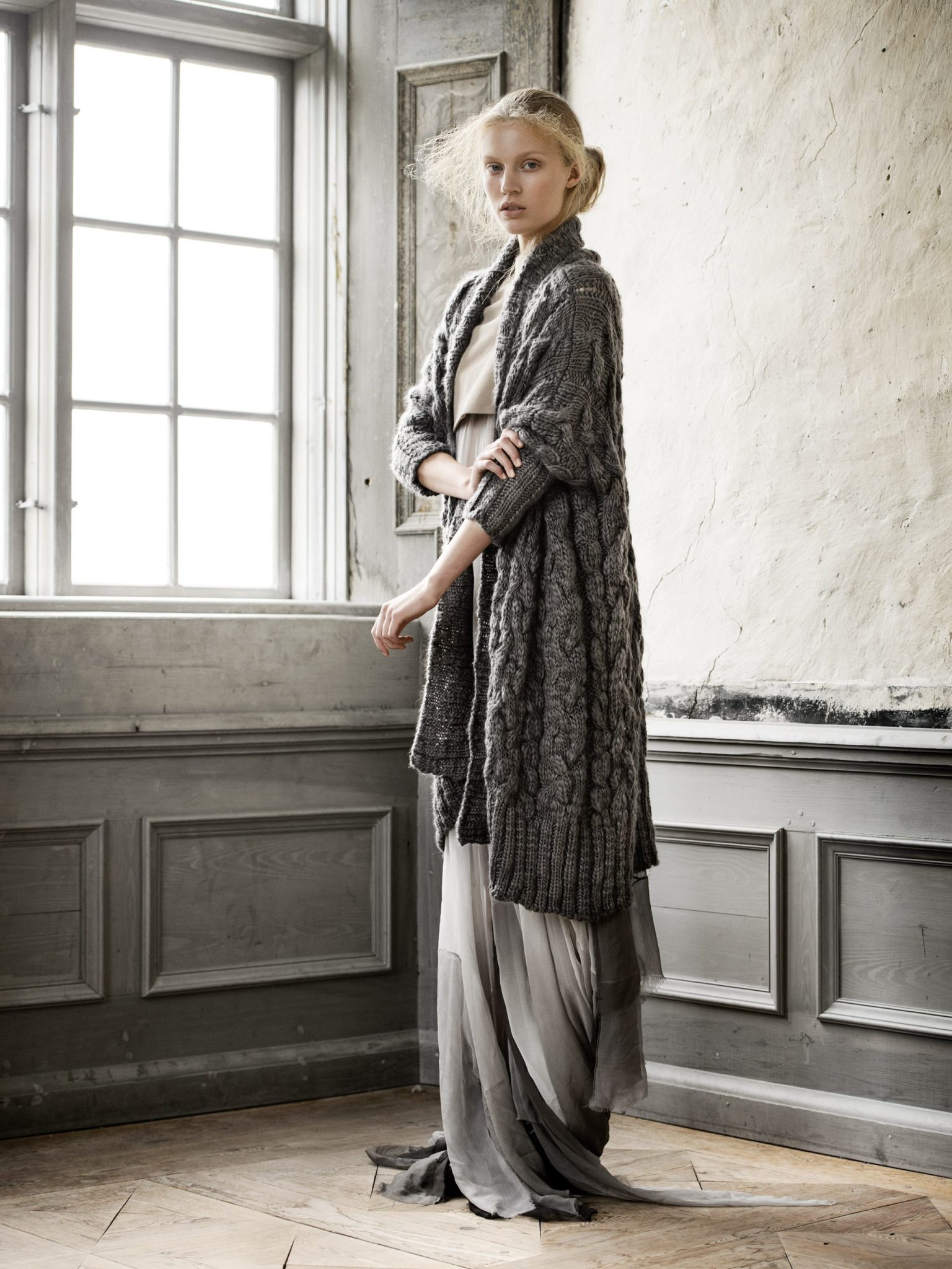 a woman in a long sweater and dress
